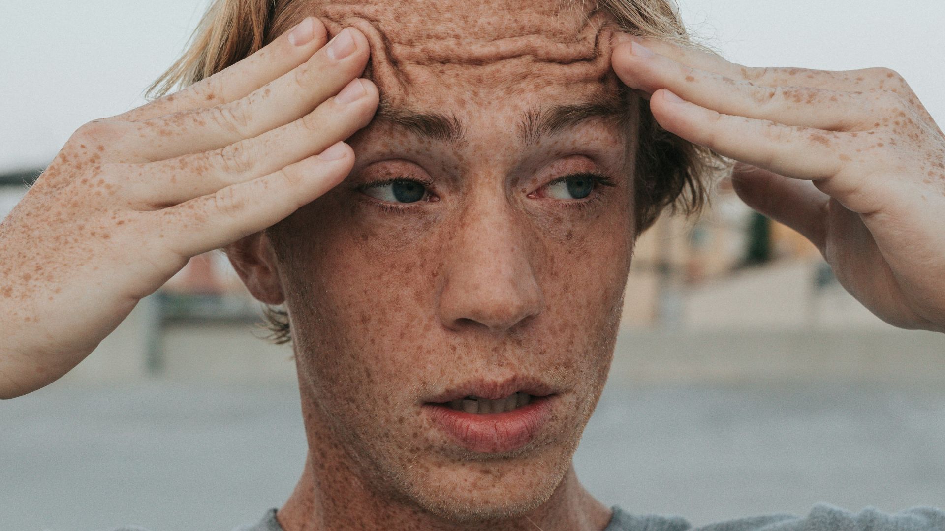 man in gray crew neck shirt with brown hair
