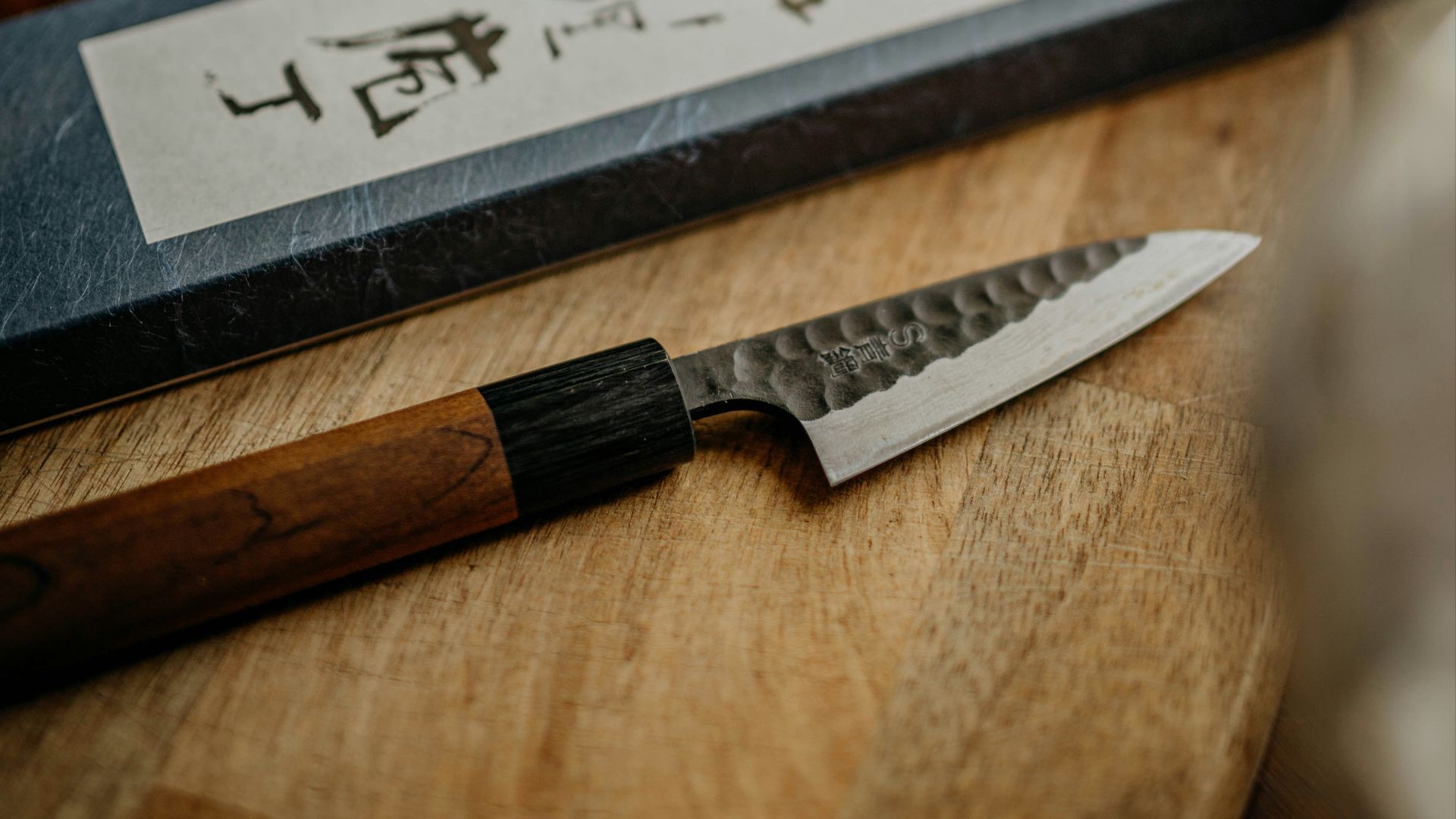 black and silver knife on brown wooden chopping board
