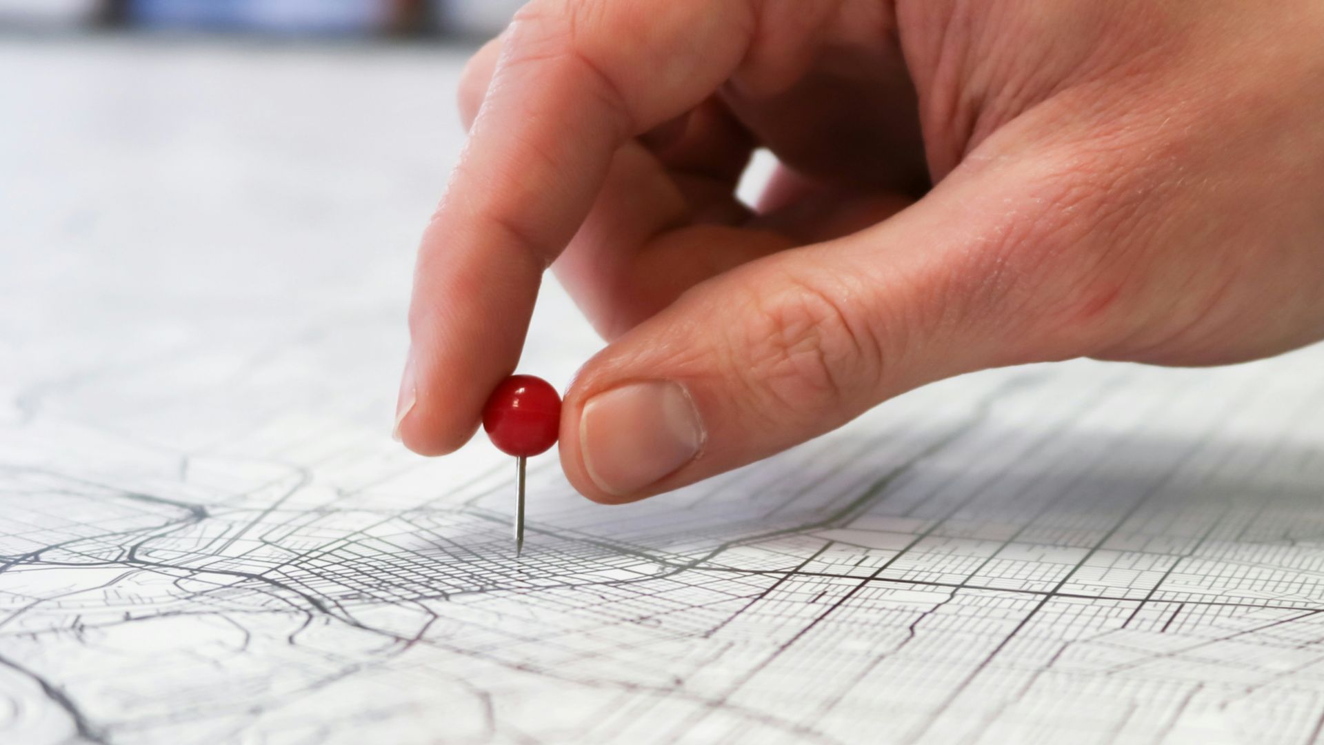 person holding red round medication pill