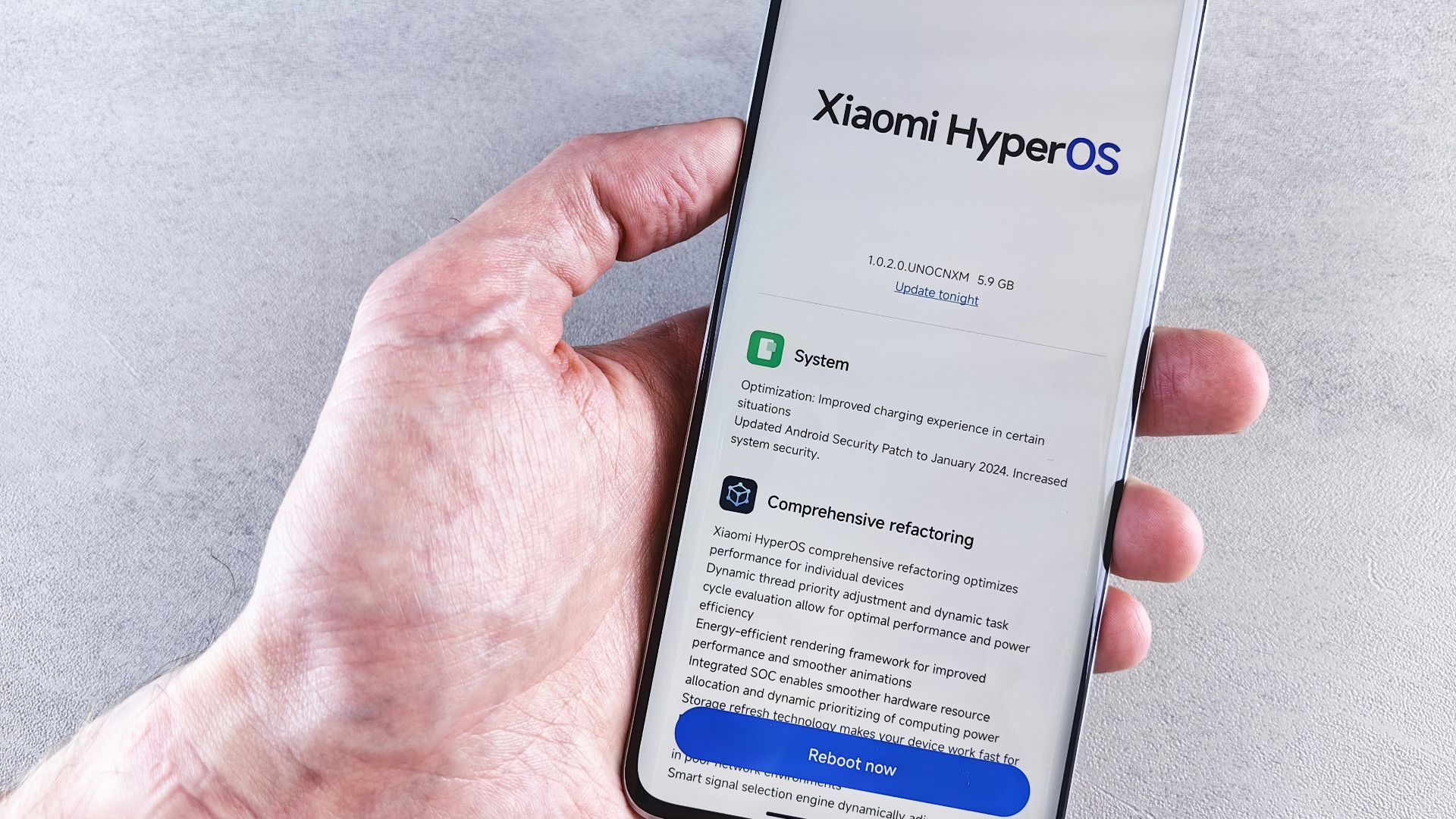A hand is holding a phone with xiaomi hyperos.