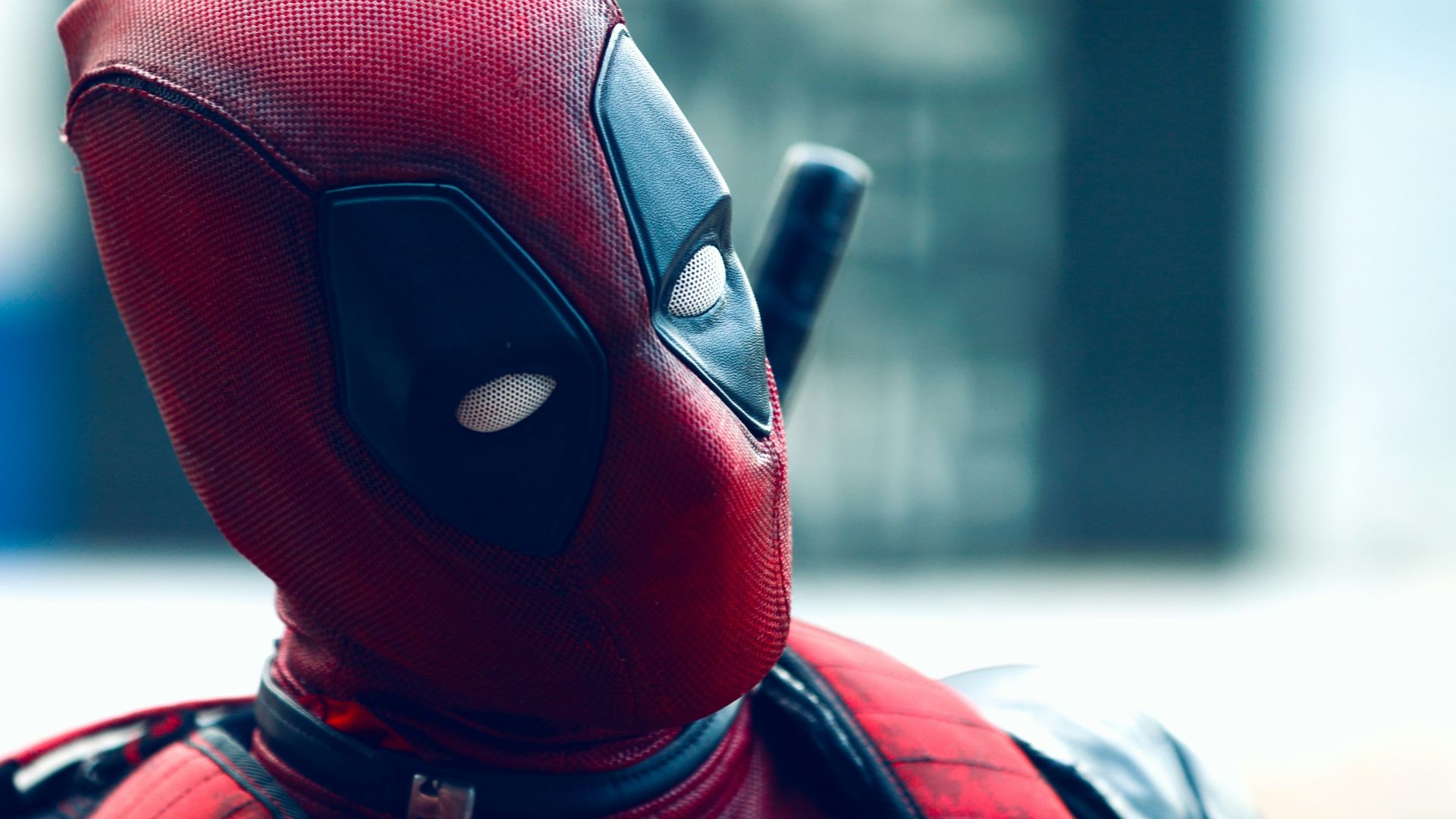 a man in a deadpool costume with a knife in his hand