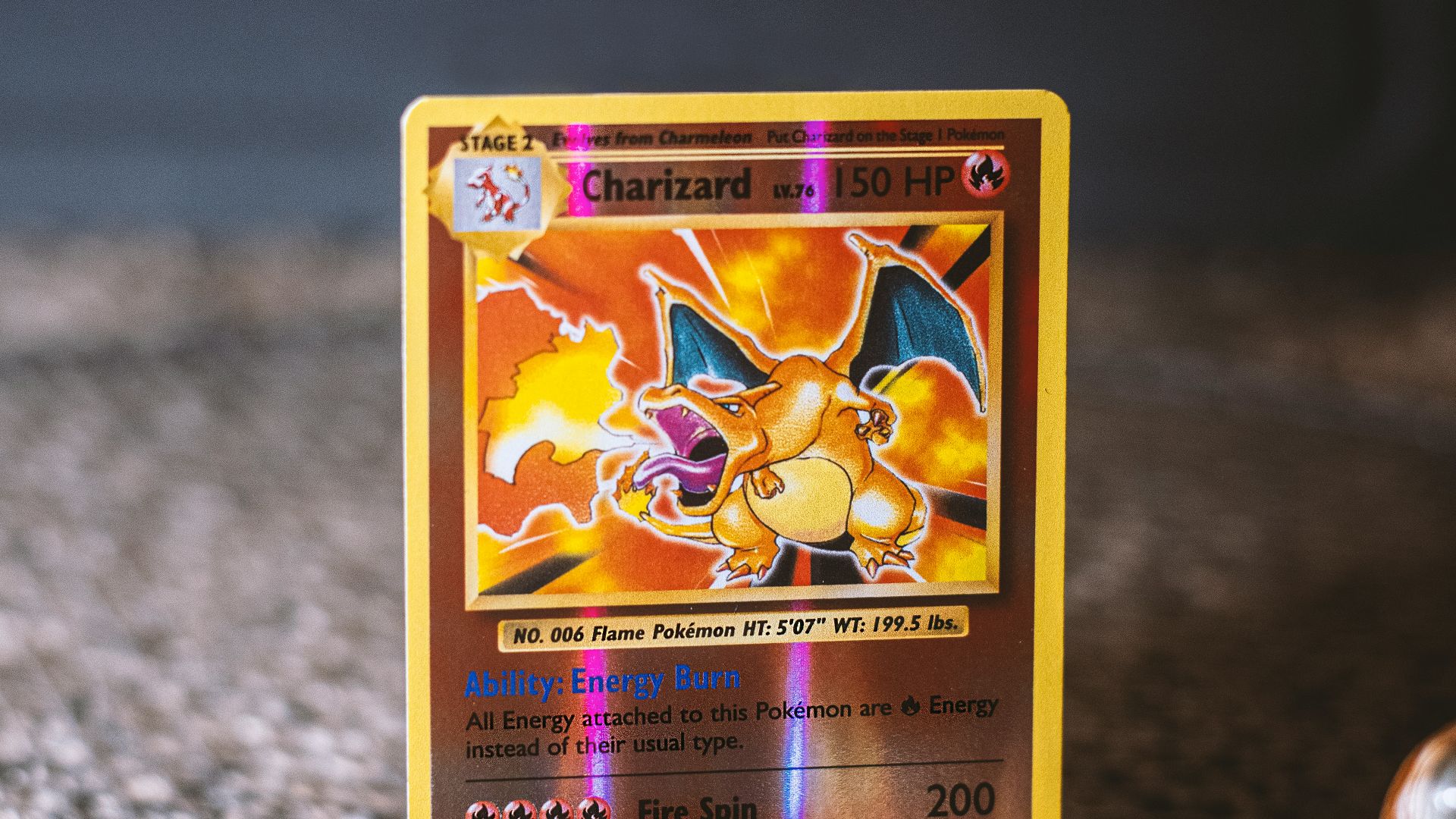 pokemon trading card on gray textile