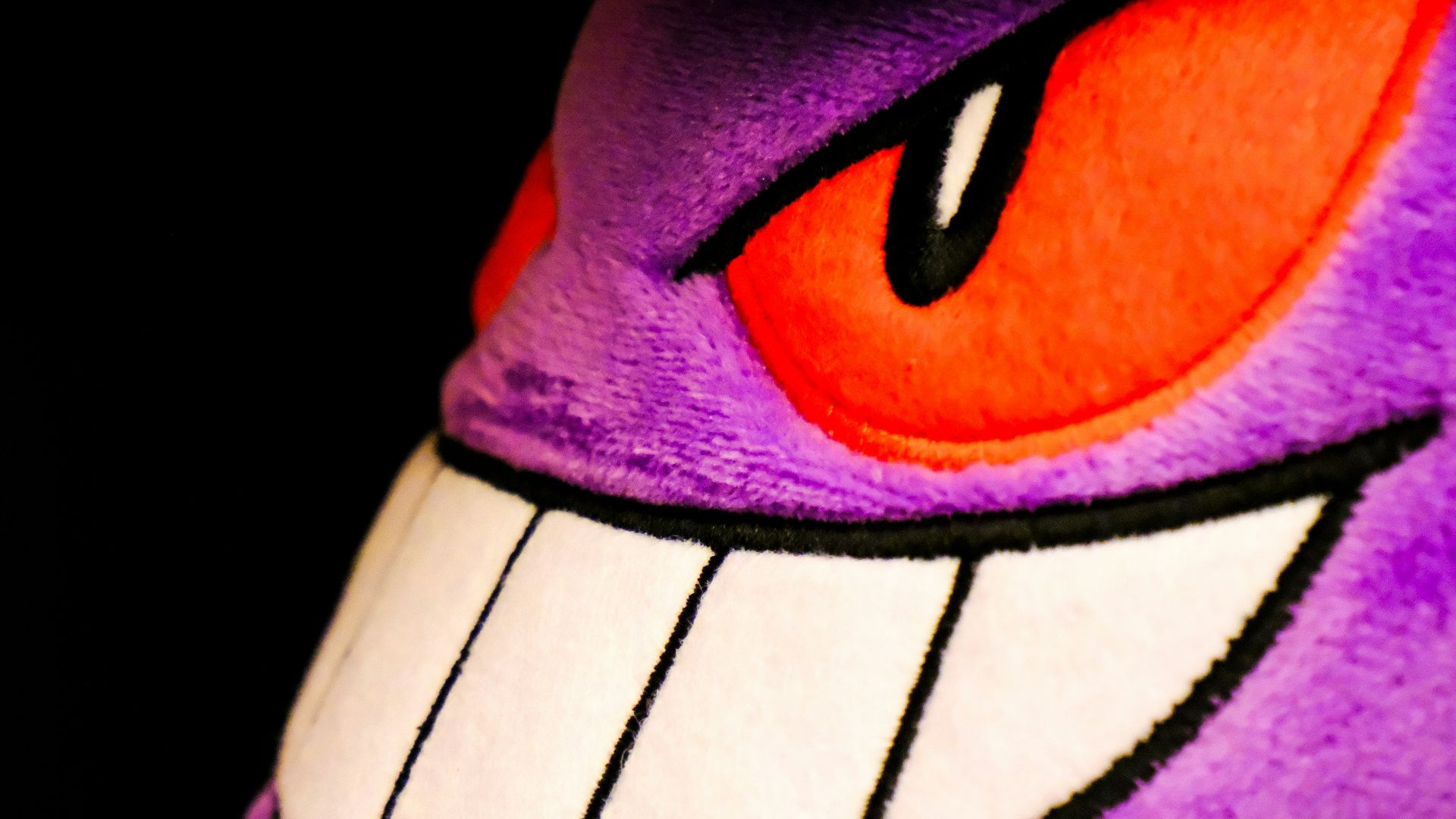 A close up of a stuffed animal wearing a hat