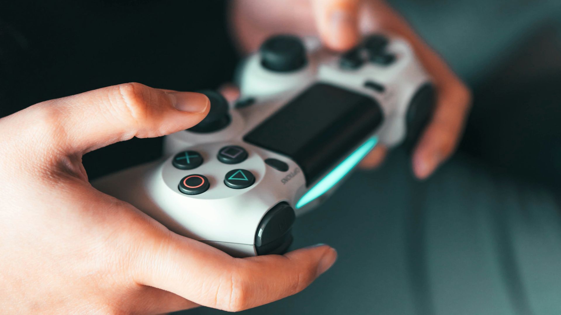 person holding gray game controller