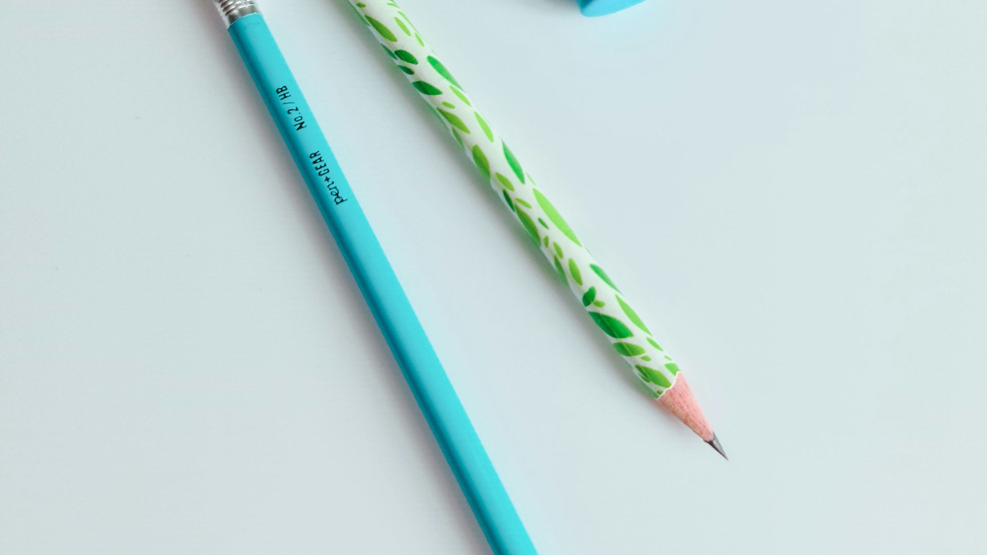 a pencil and eraser sitting next to each other