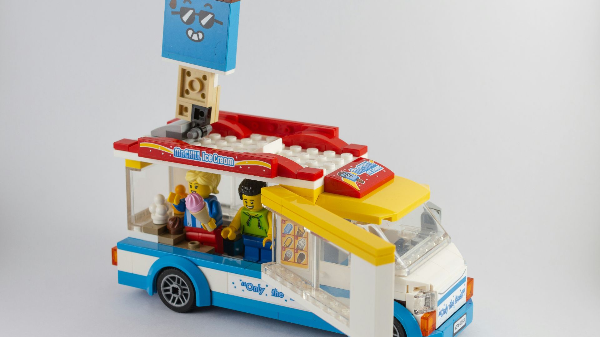 a lego food truck with people inside of it