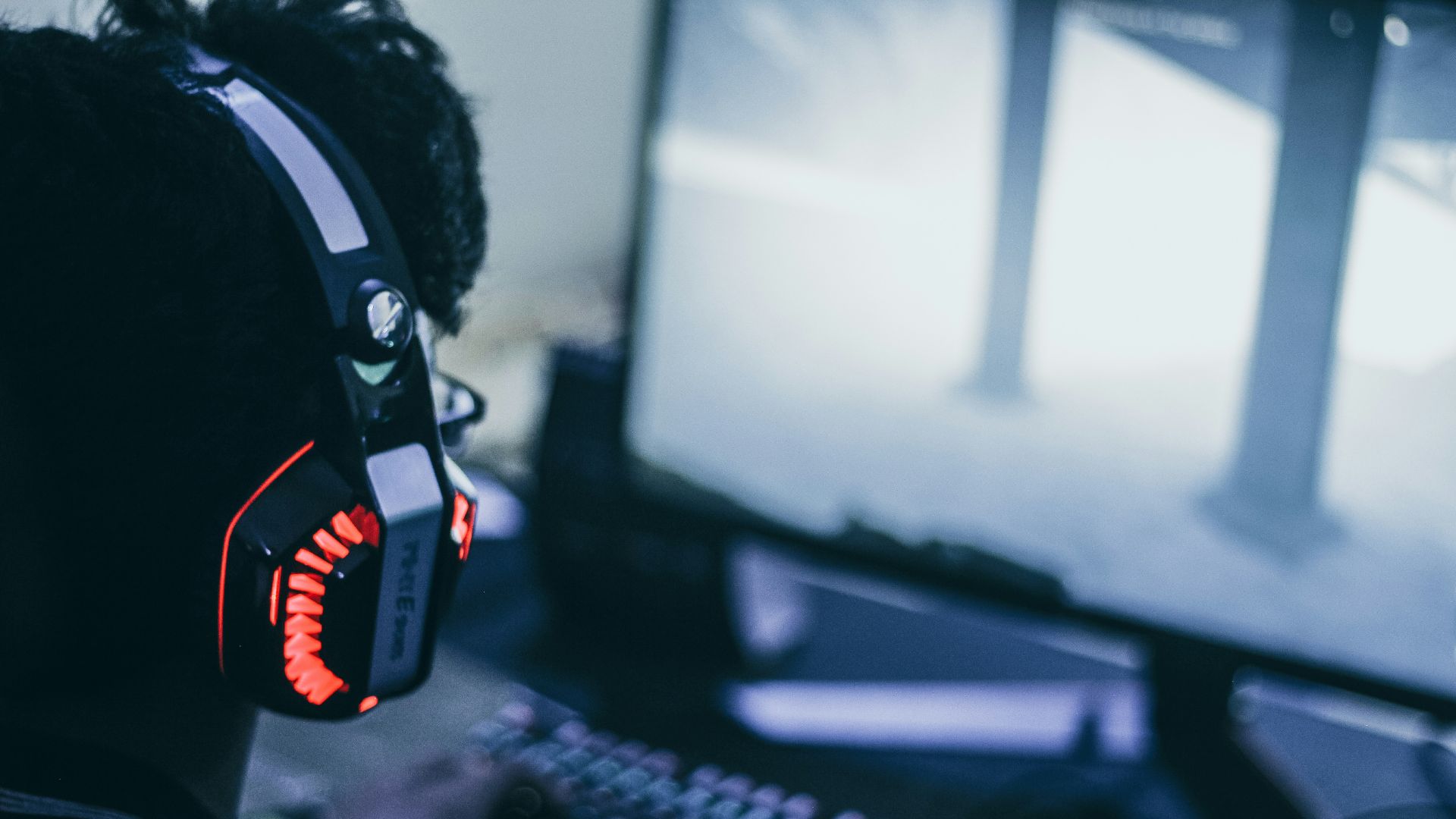 person wearing orange and black headphones