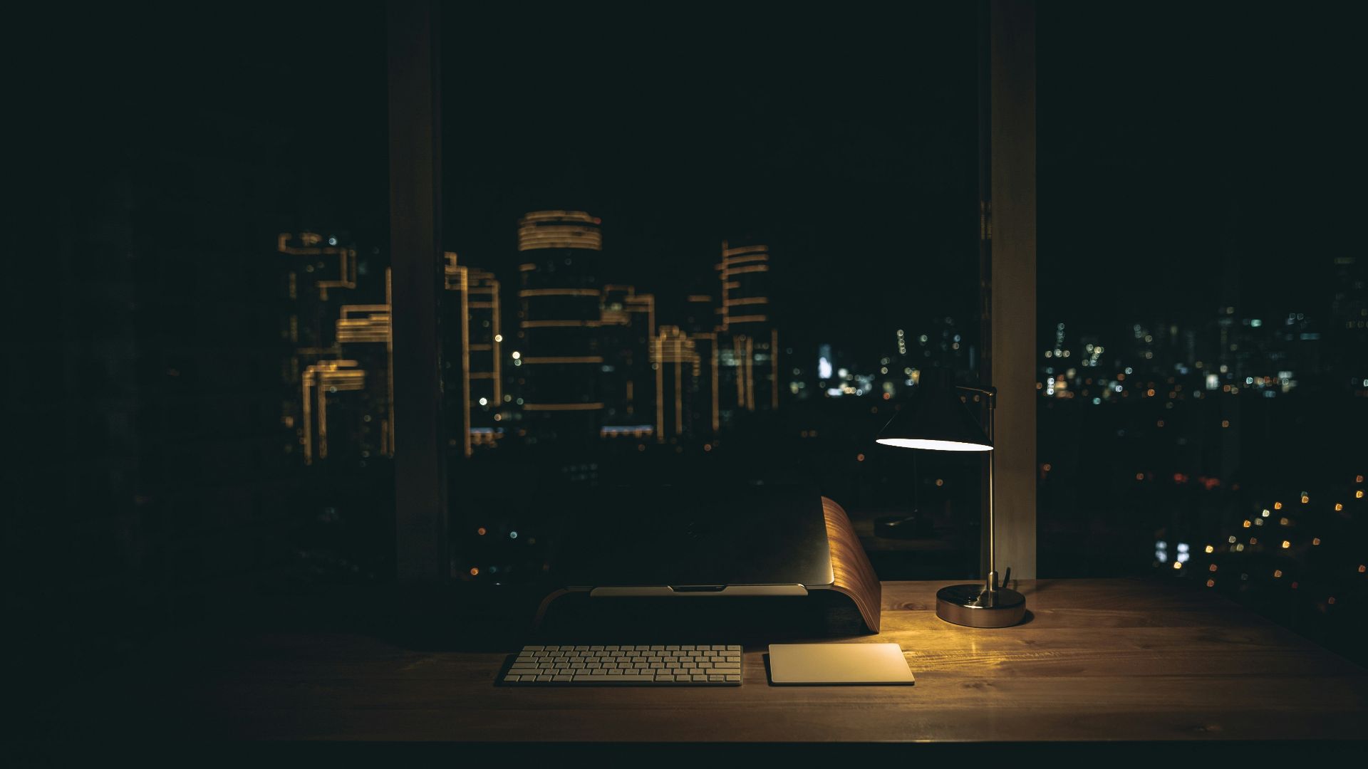 lit desk lamp on top of desk