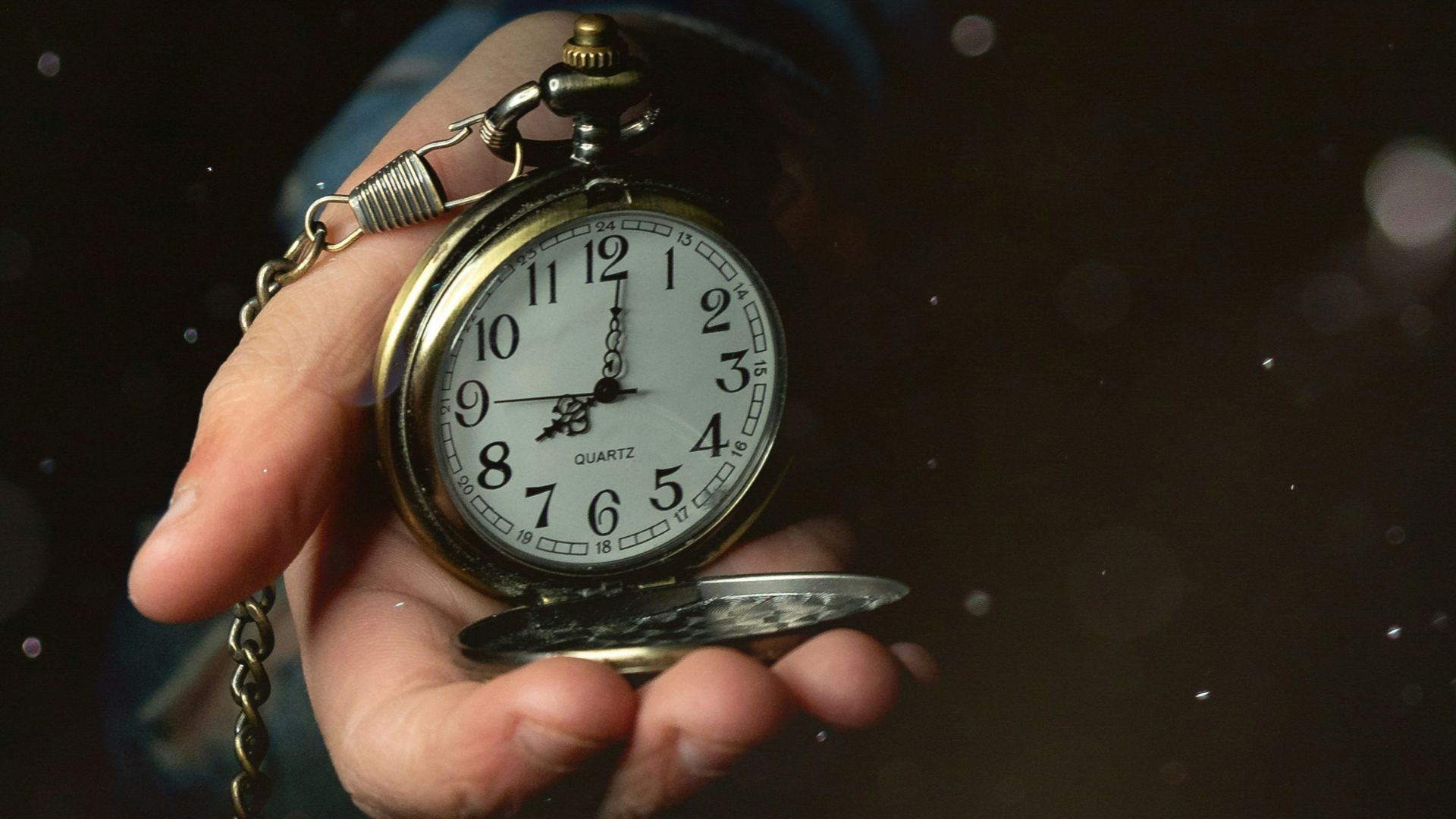 a person holding a clock in their hand