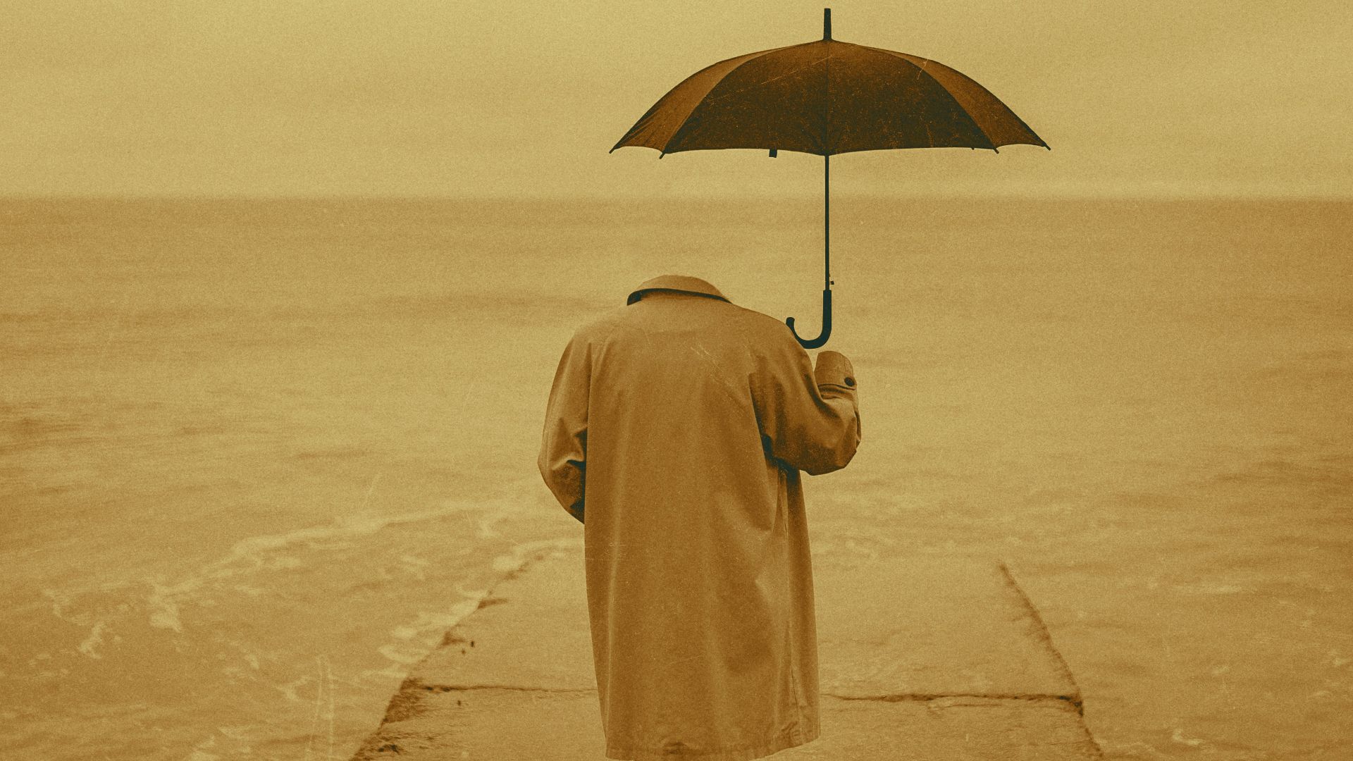 a man walking on a pier holding an umbrella