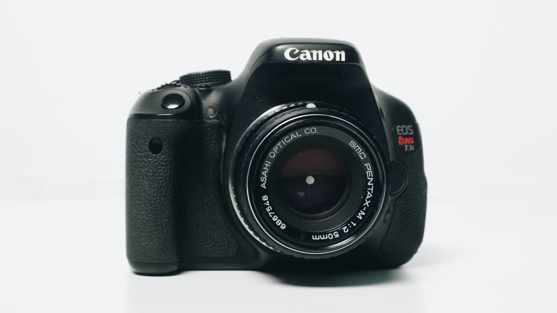 black Canon EOS Rebel-series DSLR camera
