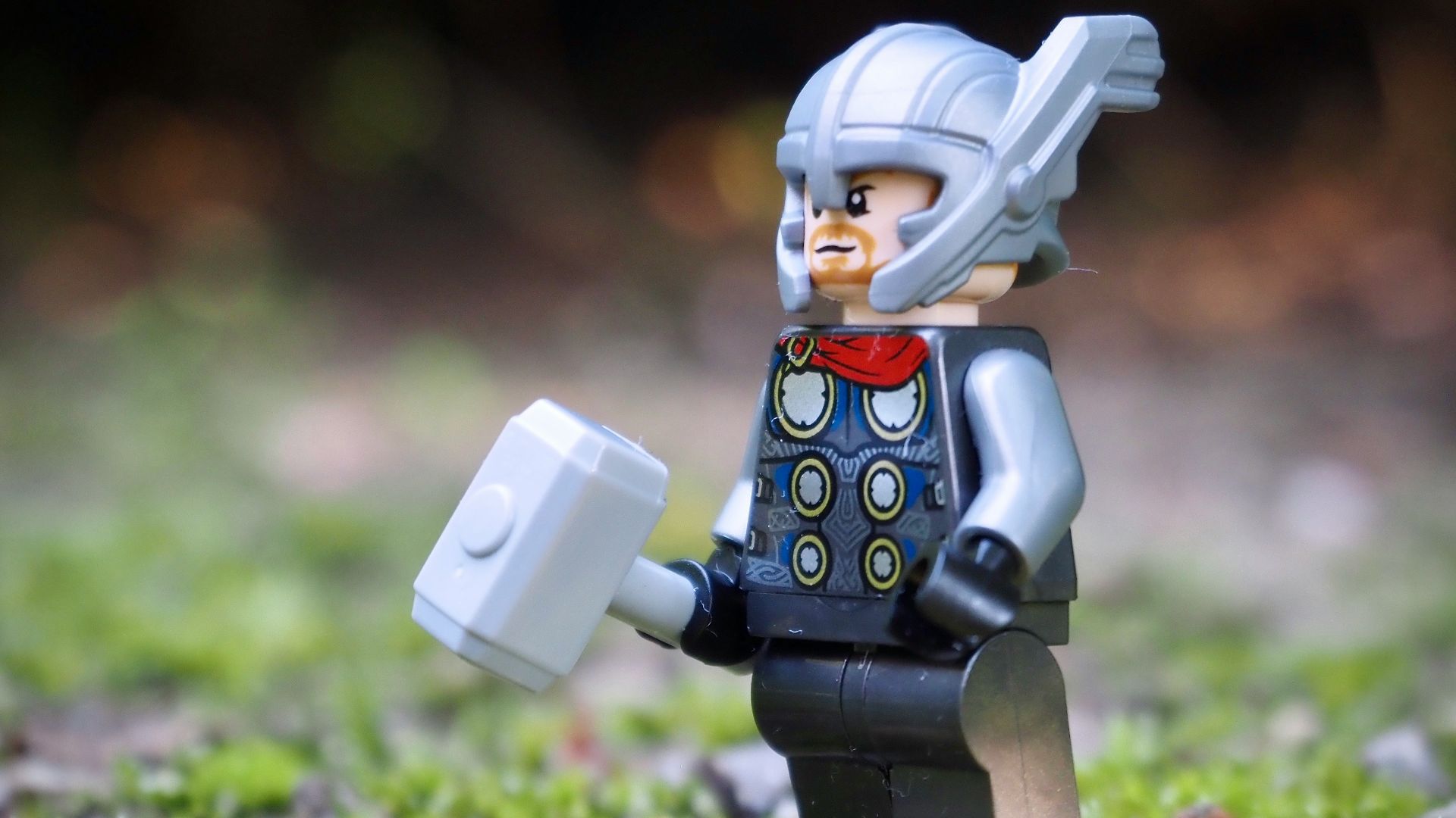 lego minifig on green grass during daytime