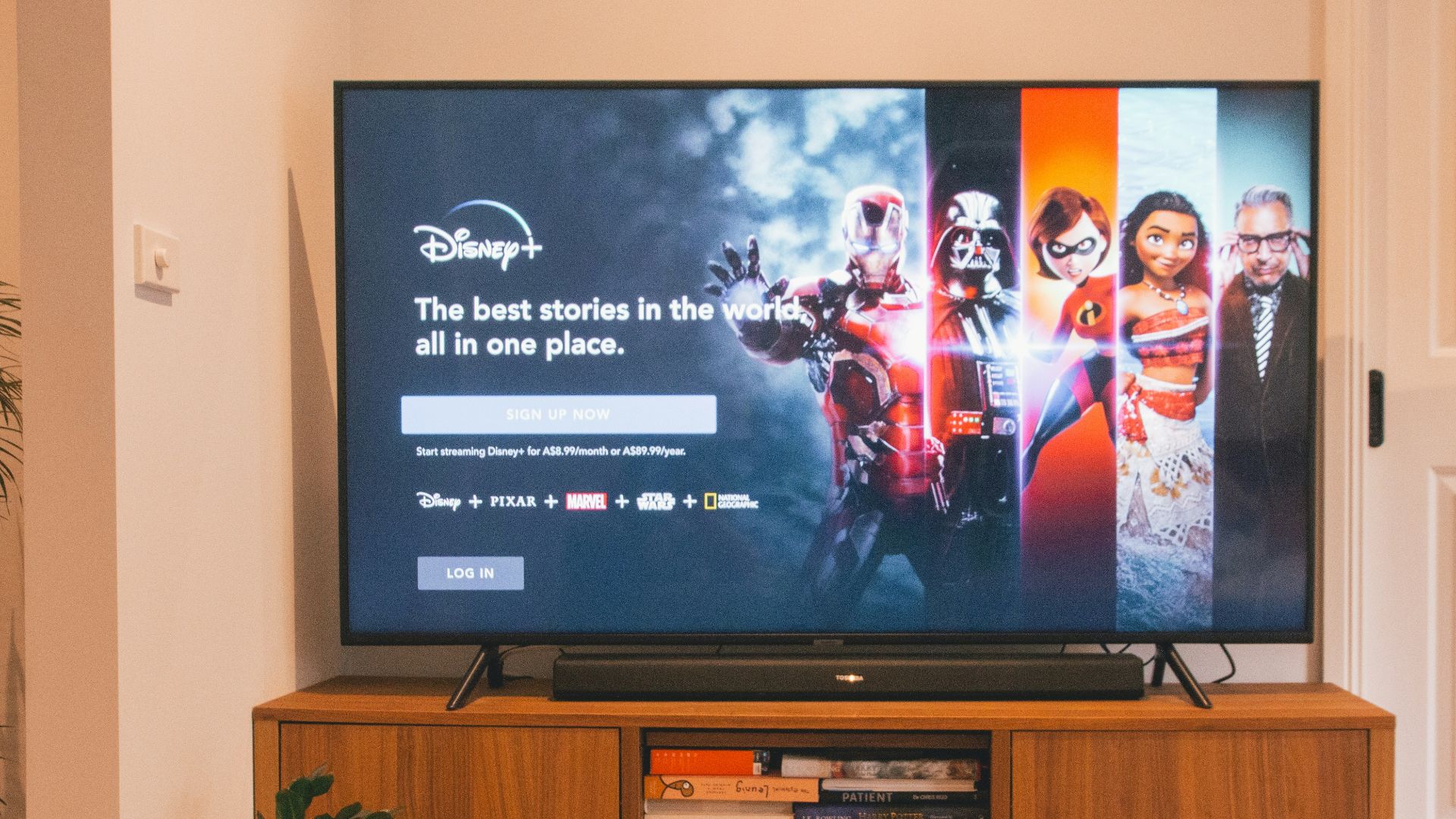 black flat screen tv turned on on brown wooden tv rack