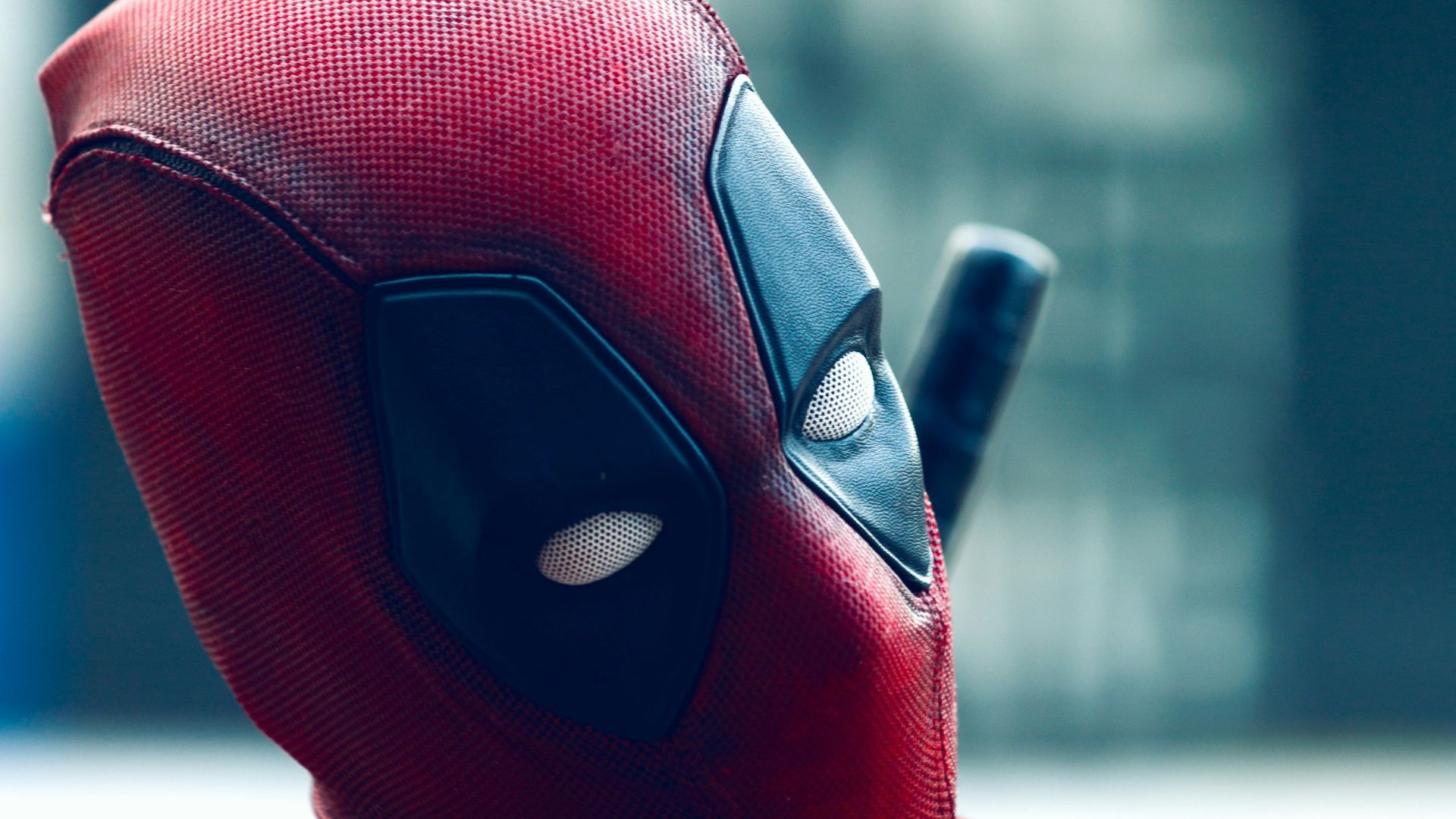 a man in a deadpool costume with a knife in his hand