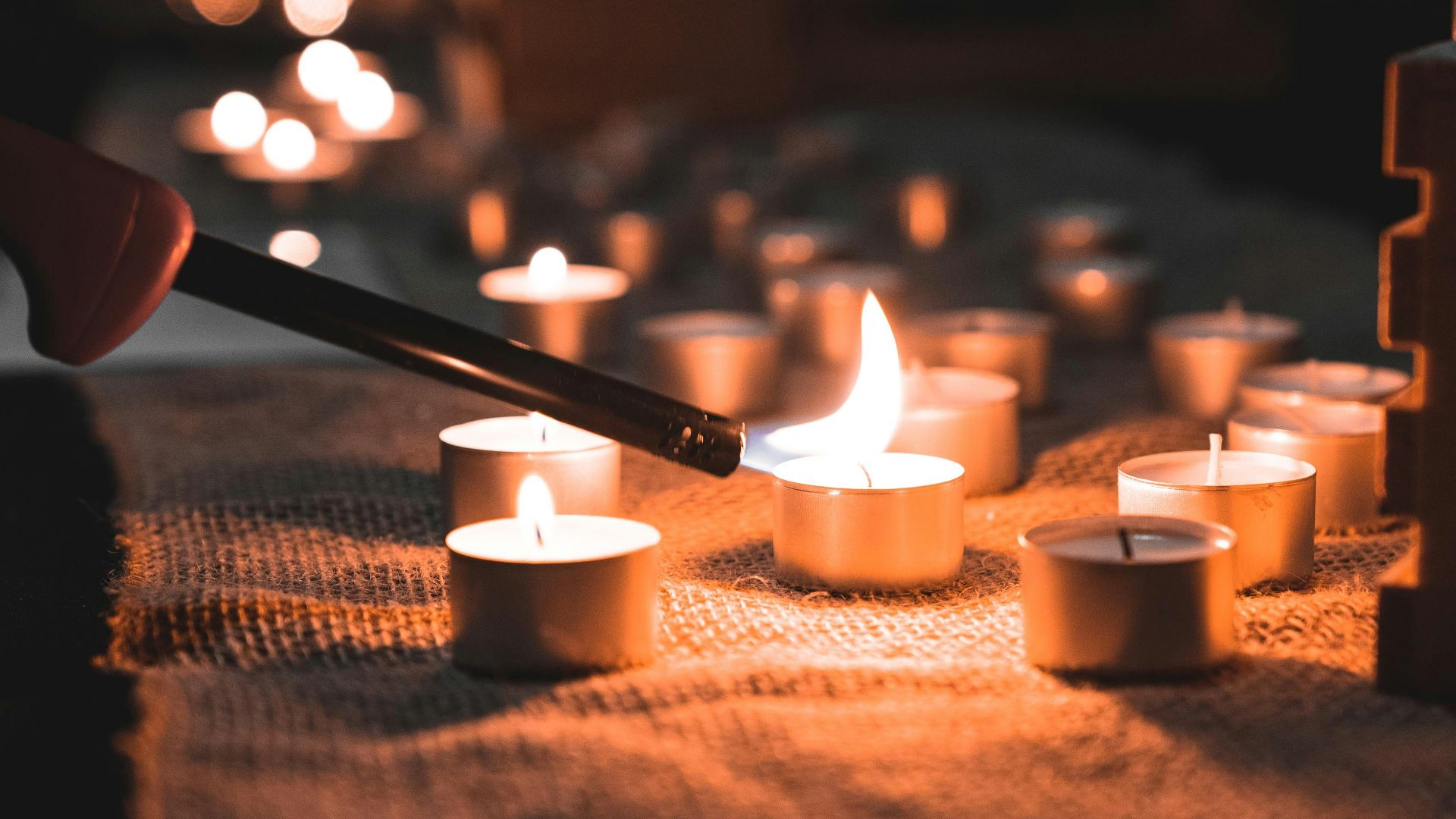 lighted candles on brown wooden table