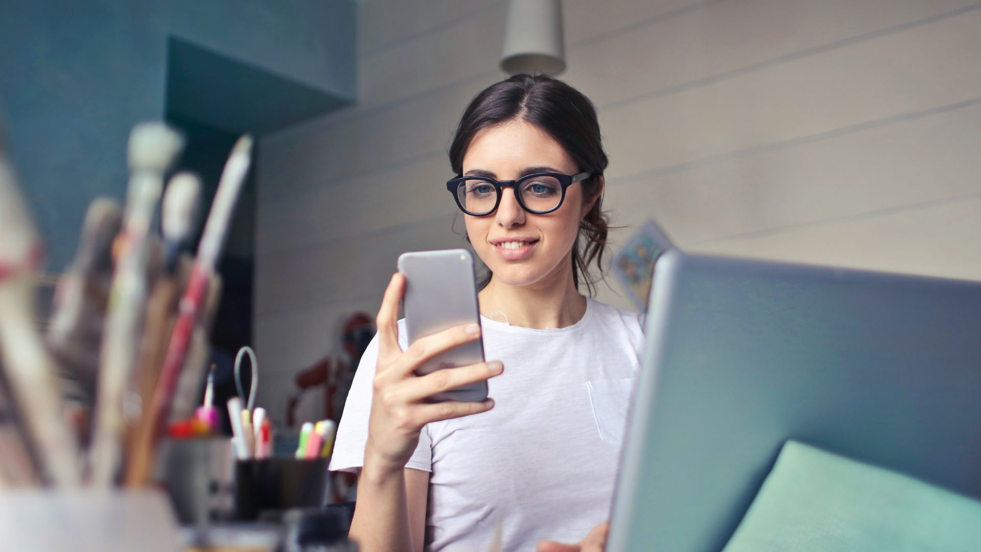woman in white shirt using smartphone