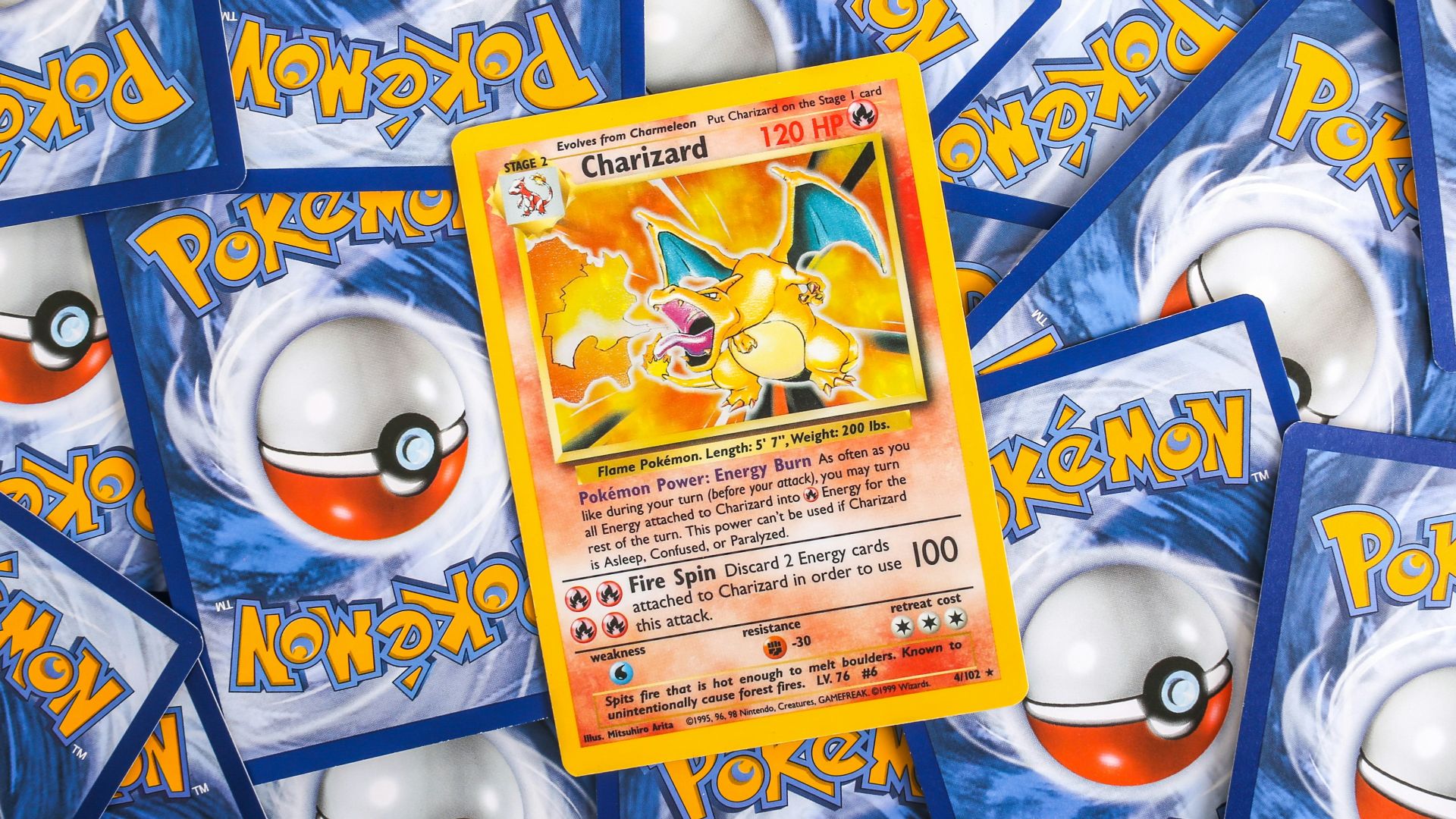 a pile of pokemon trading cards sitting on top of each other