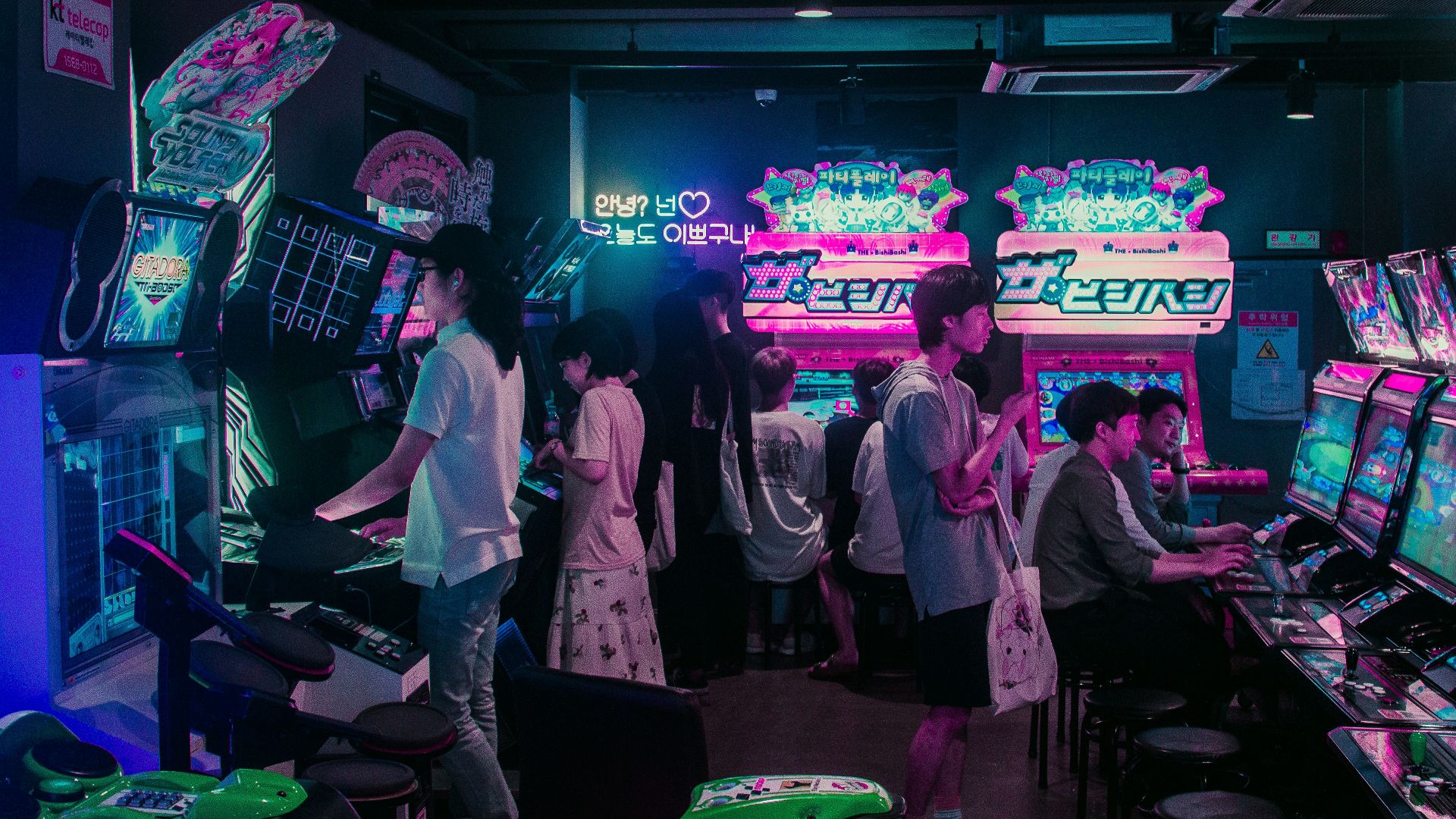 people playing arcade games