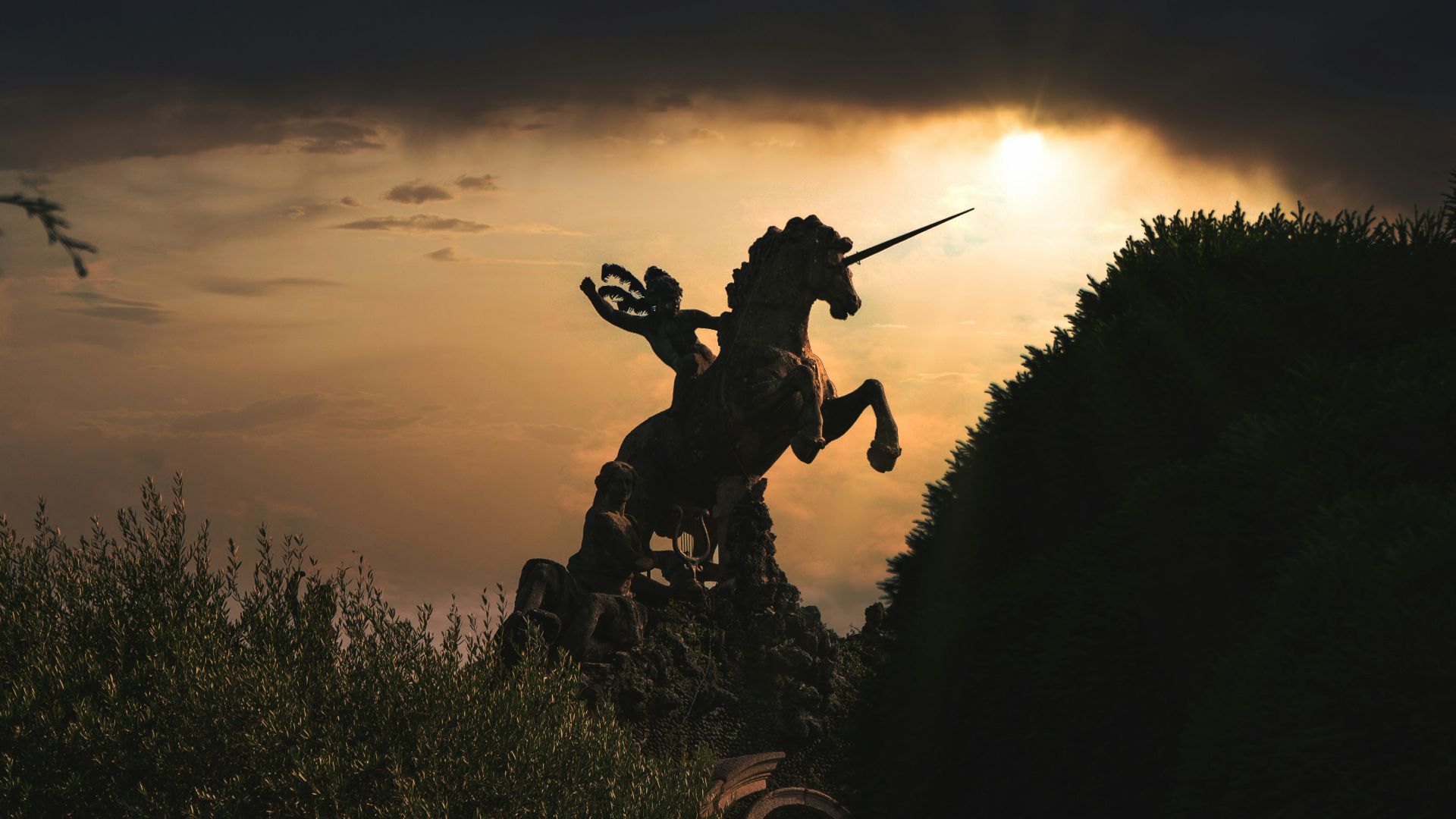 silhouette of man holding stick during sunset