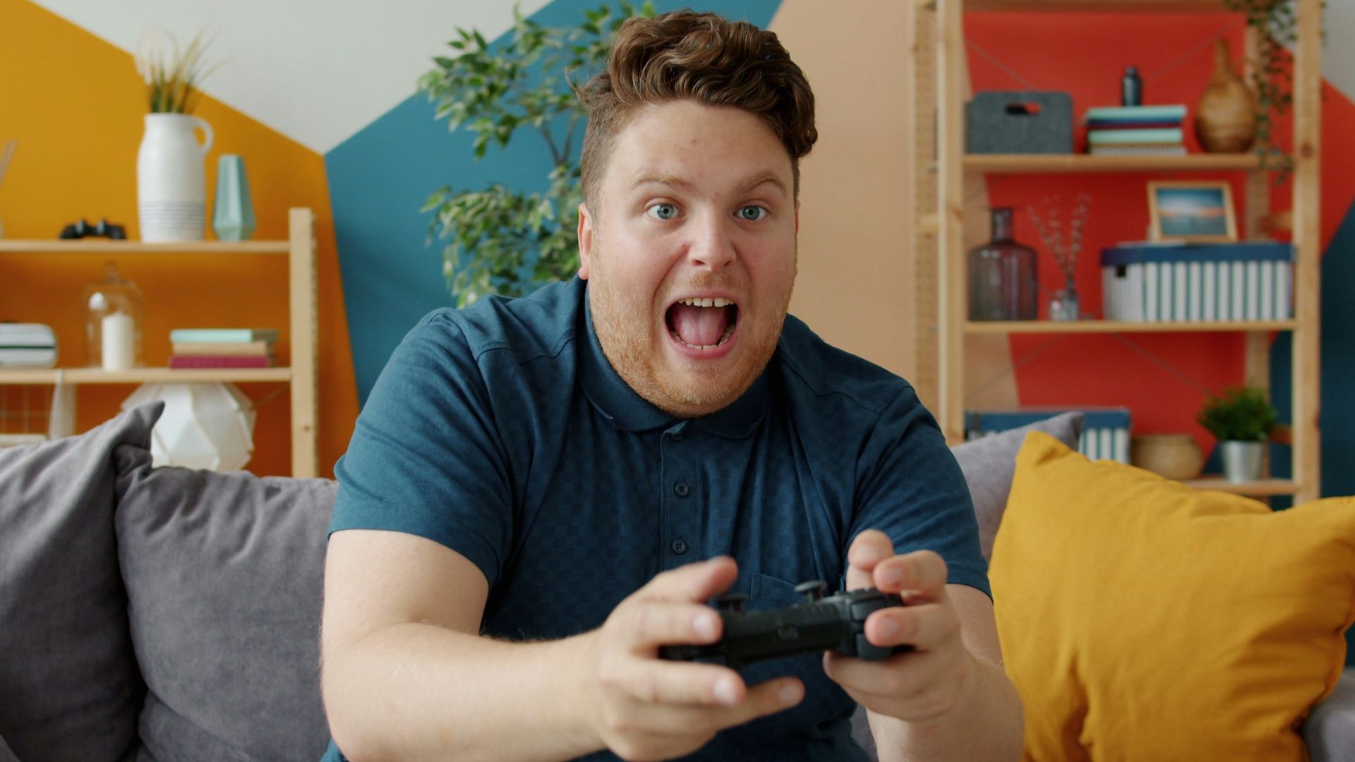Man playing video games with excited expression