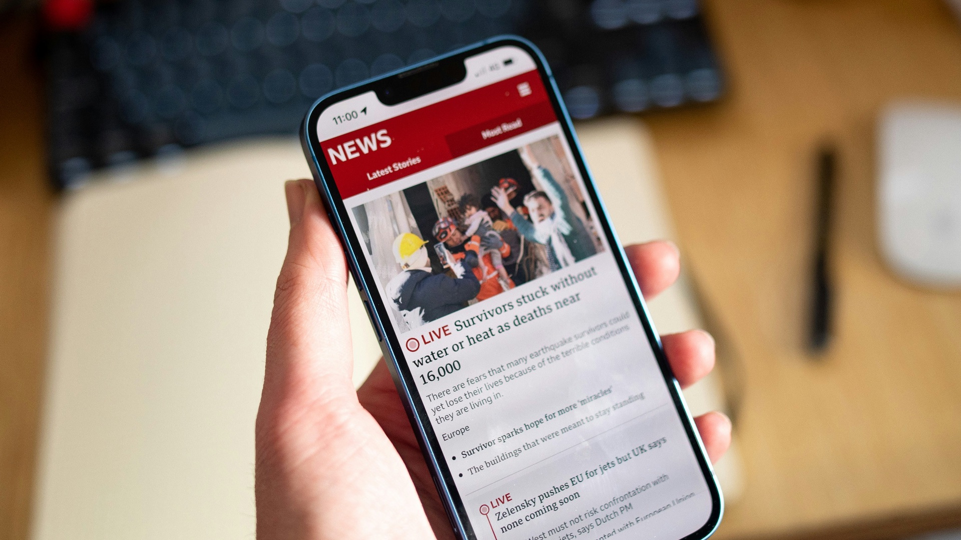 a person holding a cell phone in their hand