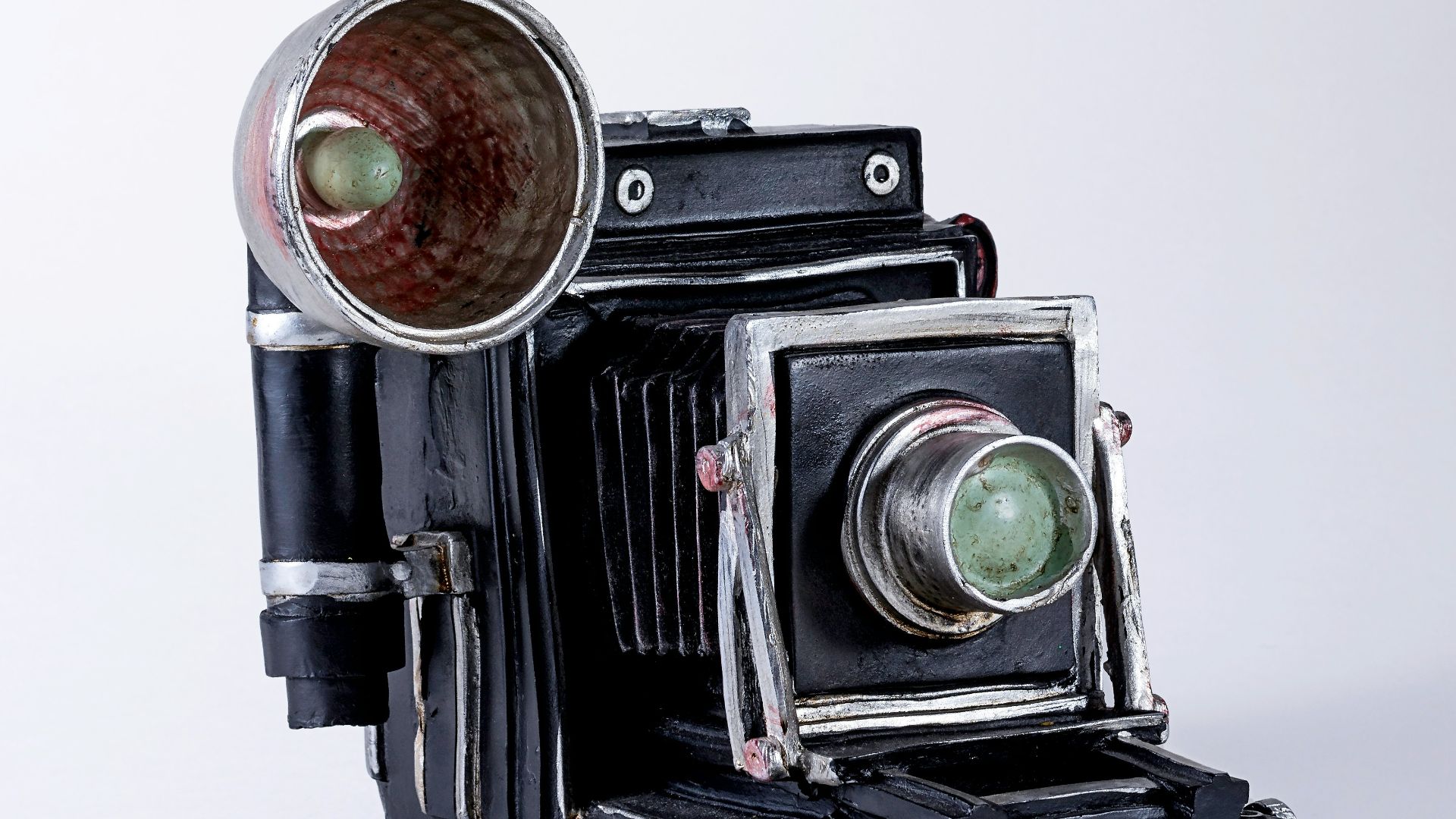 folding camera on white surface