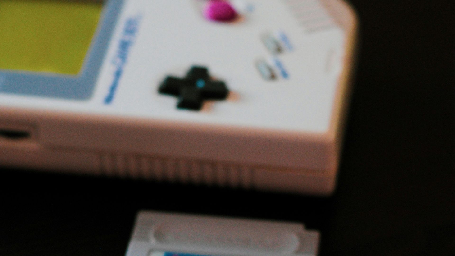 white Nintendo Game Boy controller and two cartridges