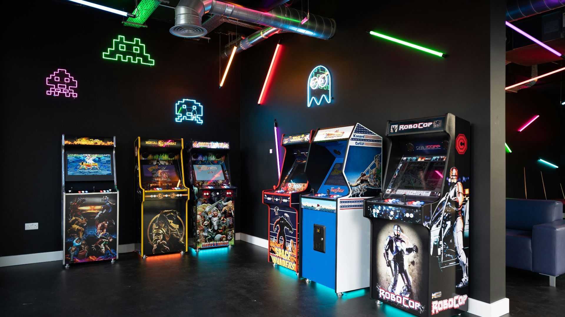 a room filled with arcade machines and neon lights