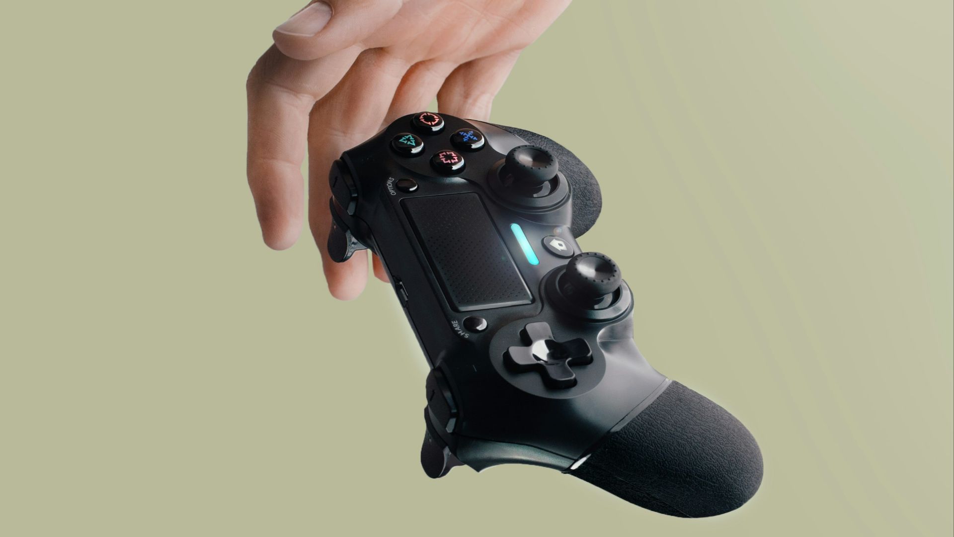 person holding Sony DualShock 4 wireless controller