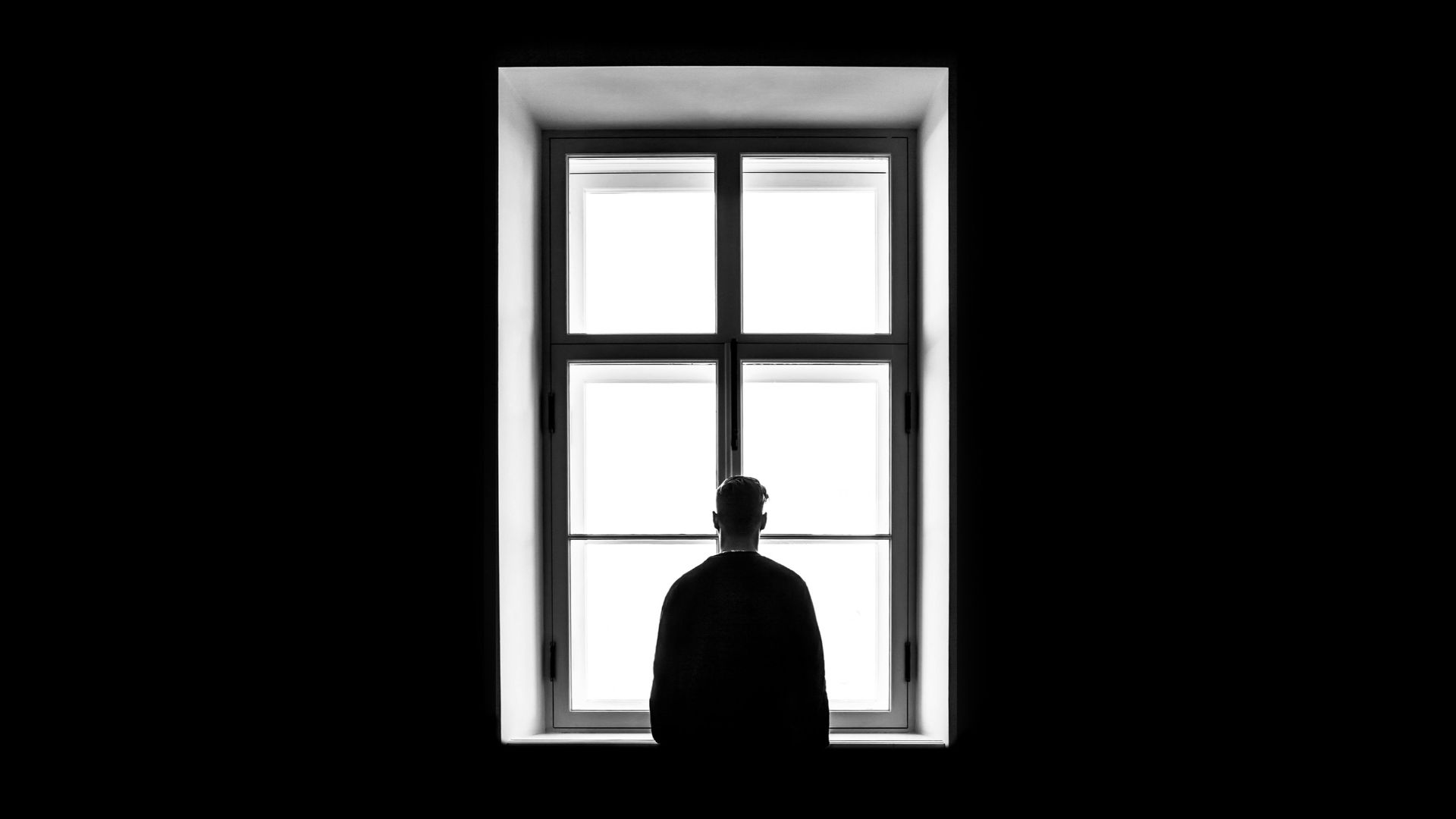 man standing in front of the window