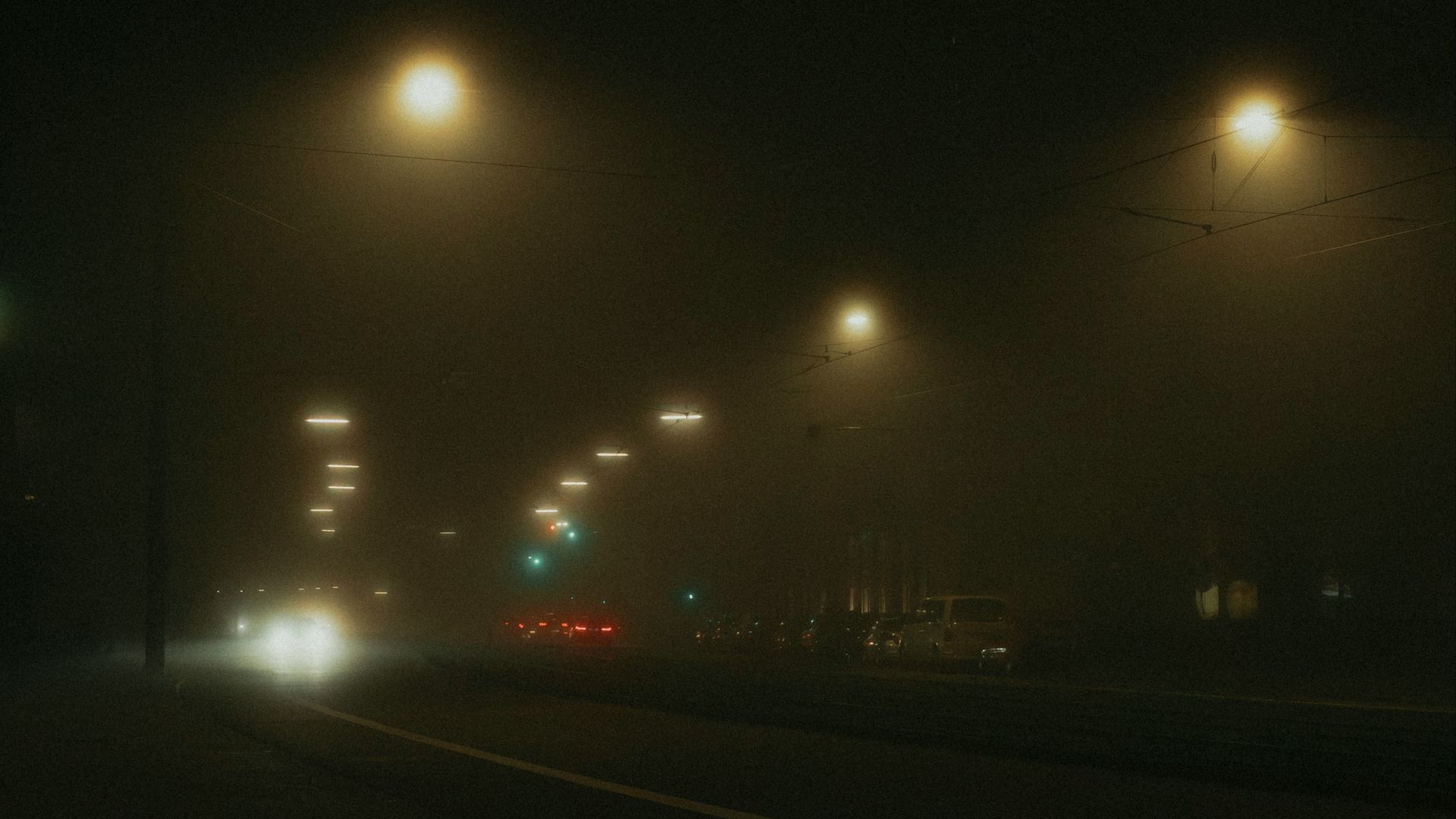 Streetlights in the fog at night