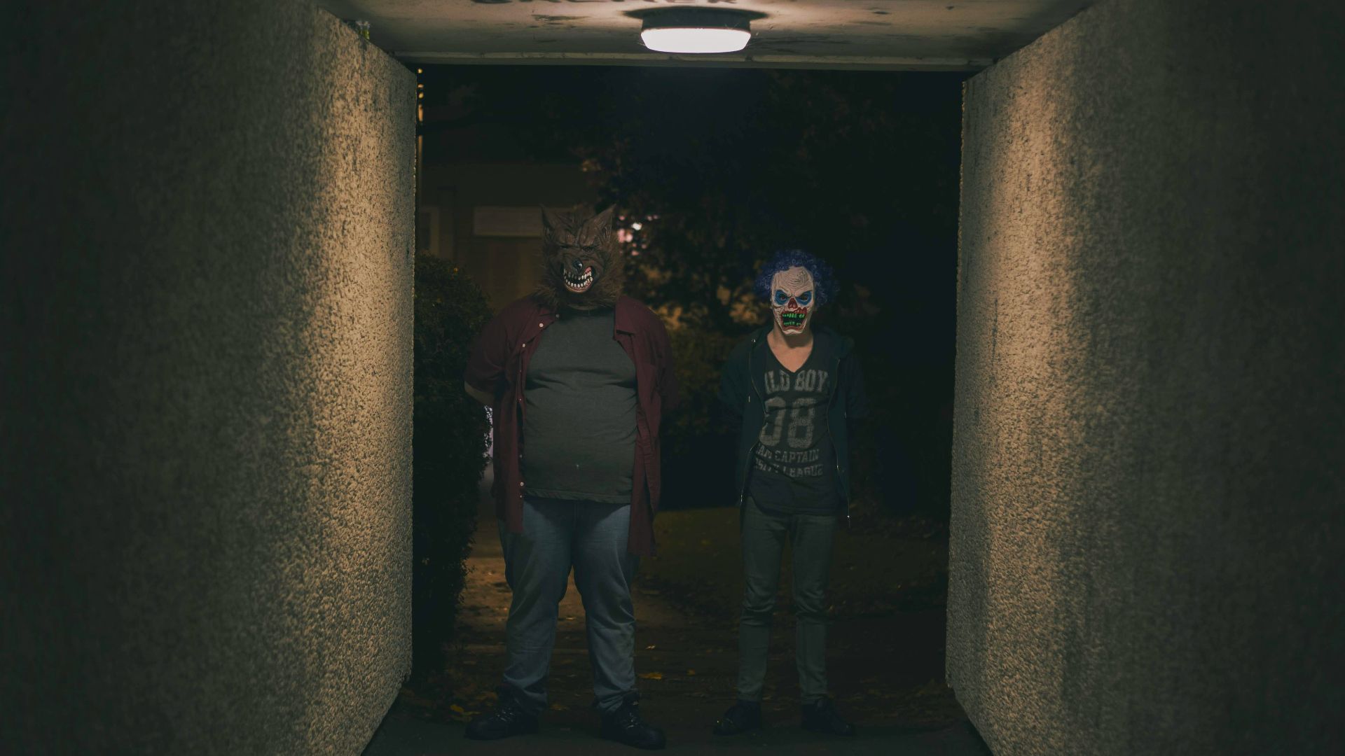 a couple of people that are standing in a hallway