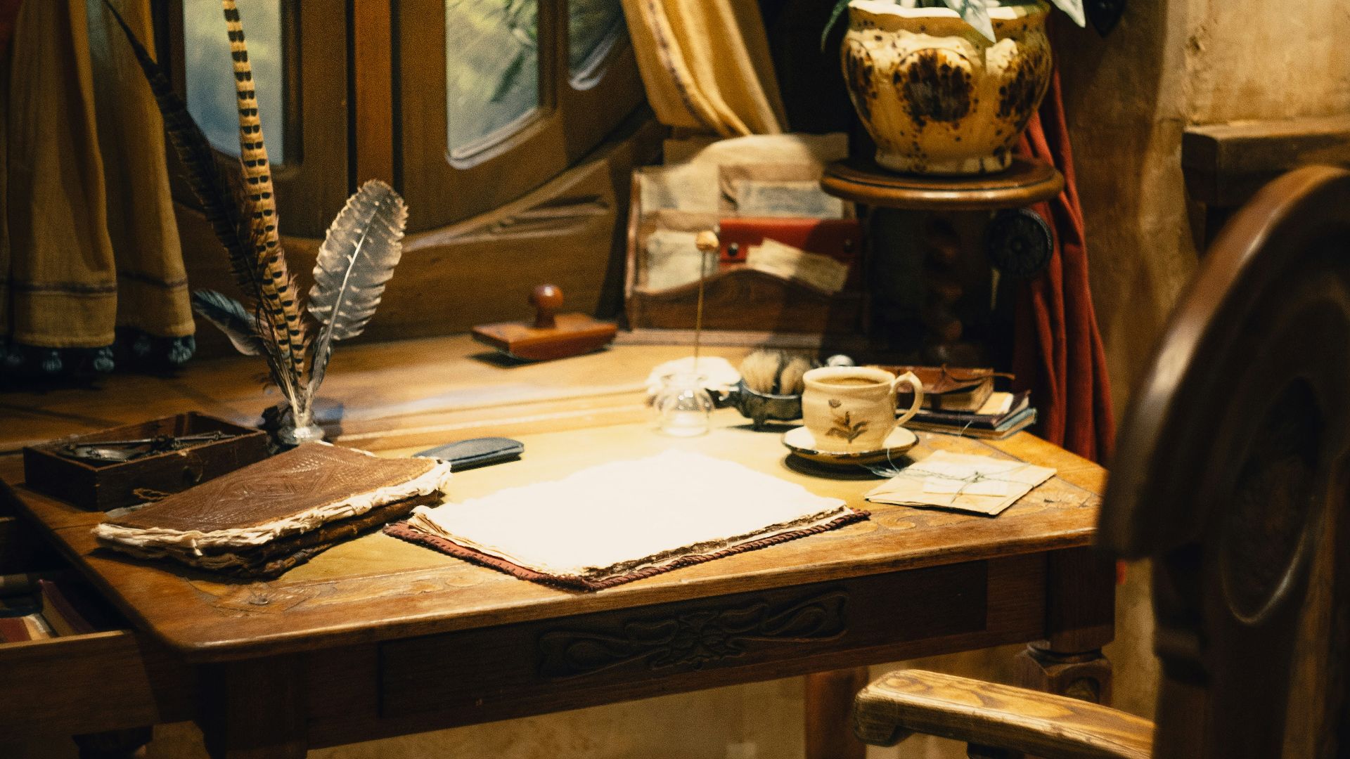 A desk with a chair and a lamp on it