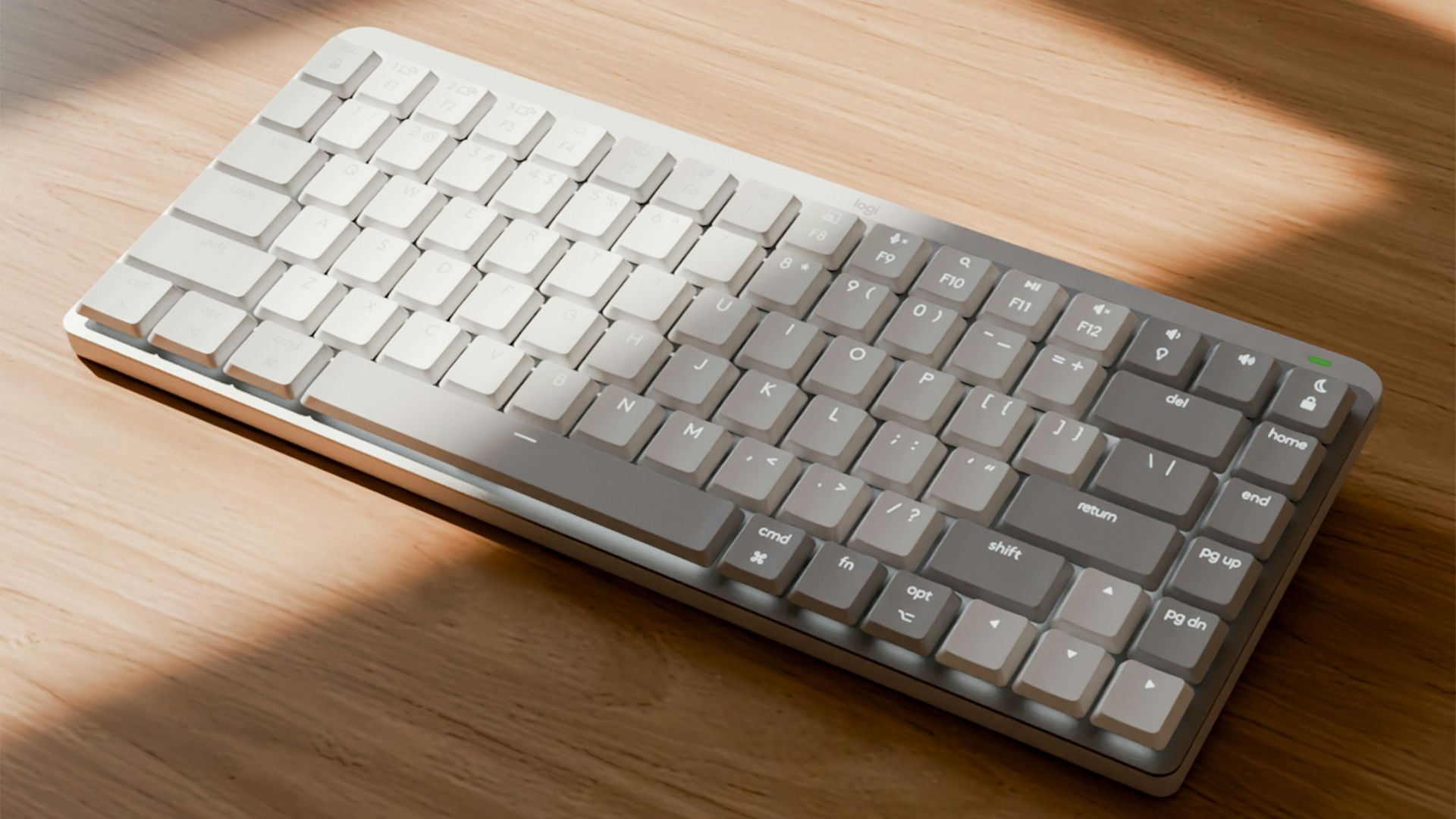 a computer keyboard sitting on top of a wooden table