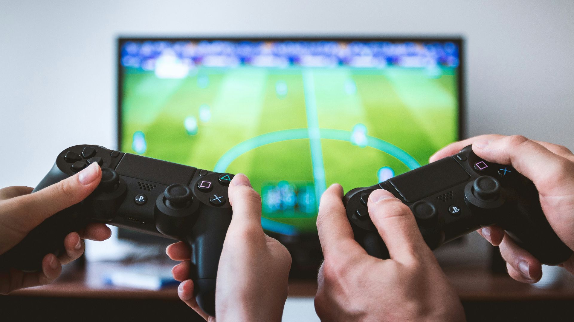 two people playing Sony PS4 game console