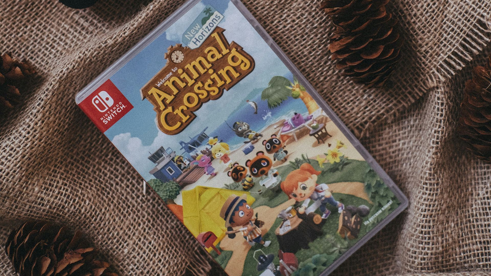 a nintendo wii game sitting on top of a blanket