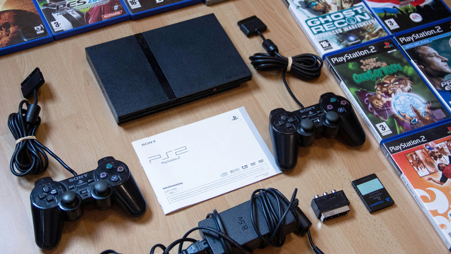 black sony ps 4 game controller on brown wooden table