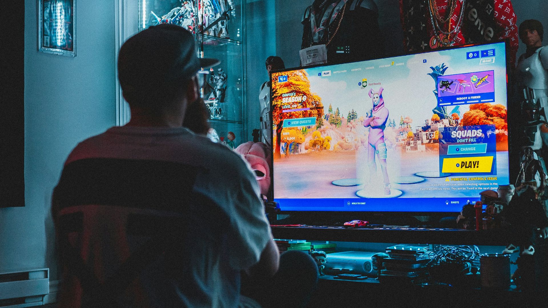 man in red shirt watching tv