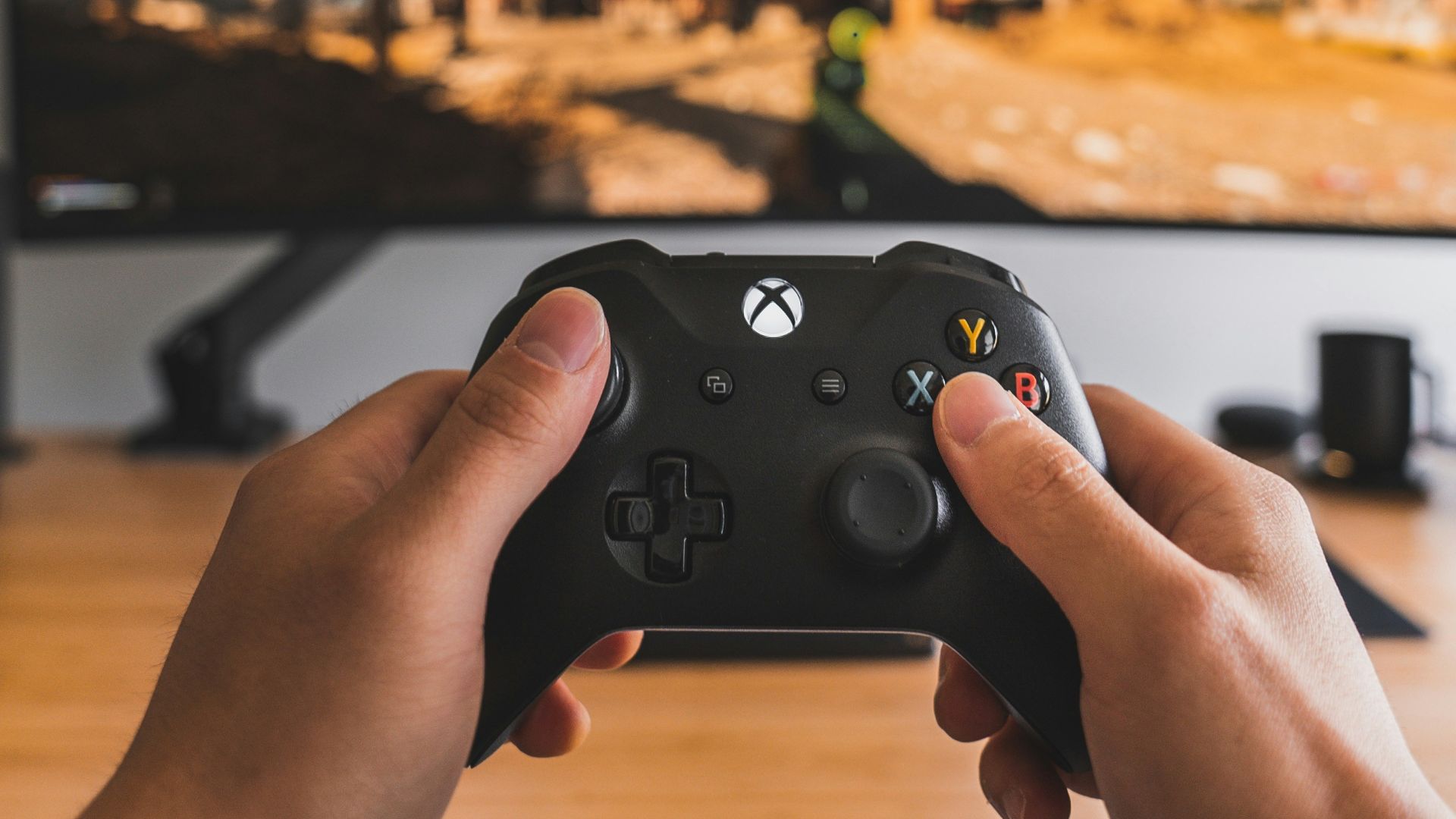 person holding black game controller