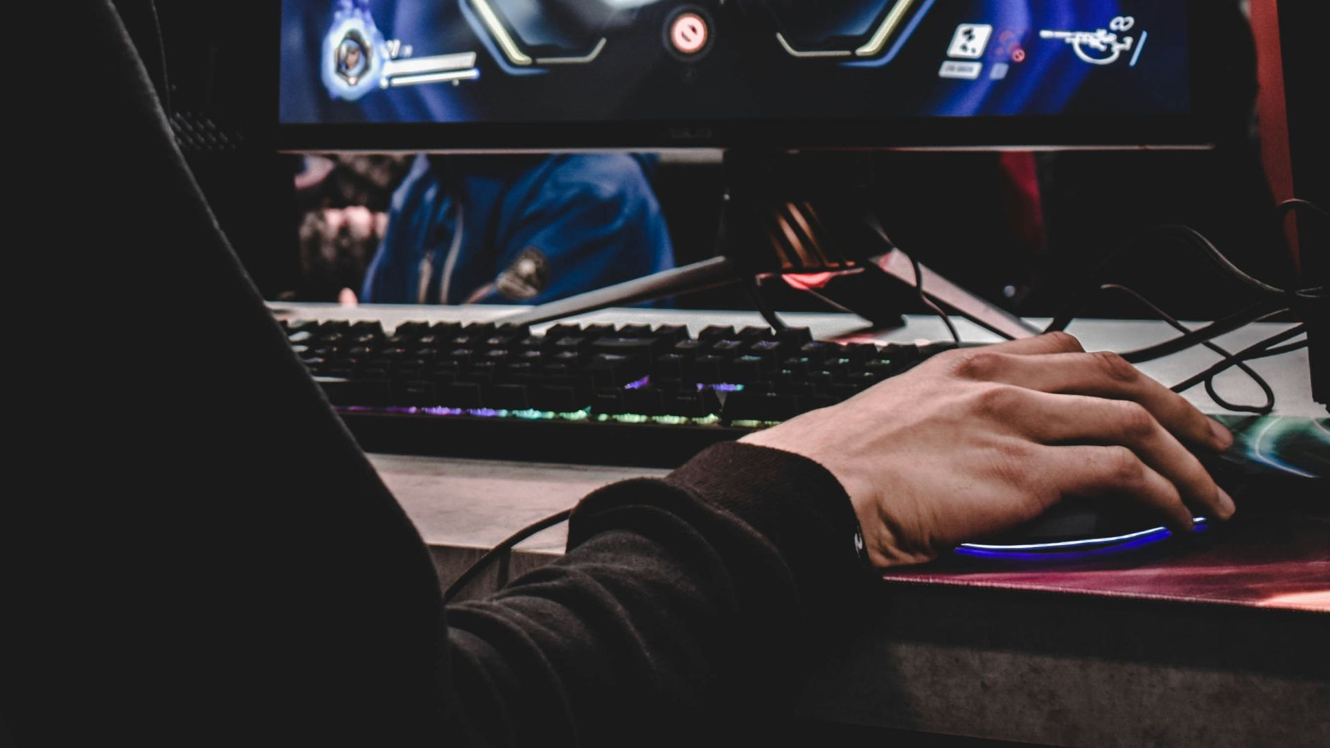 person sitting on gaming chair while playing video game