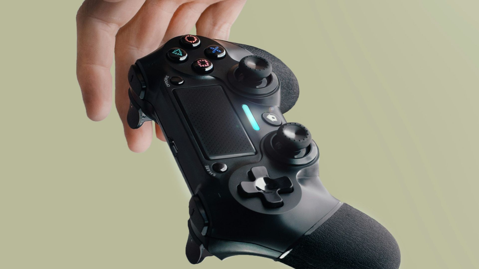 person holding Sony DualShock 4 wireless controller