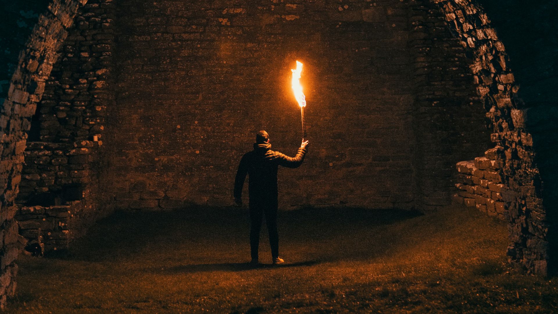 person holding torch in building interior