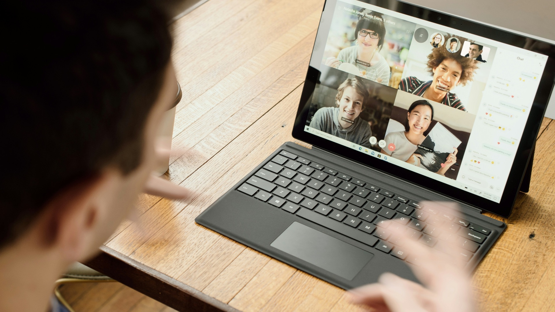 person in blue long sleeve shirt using black Surface