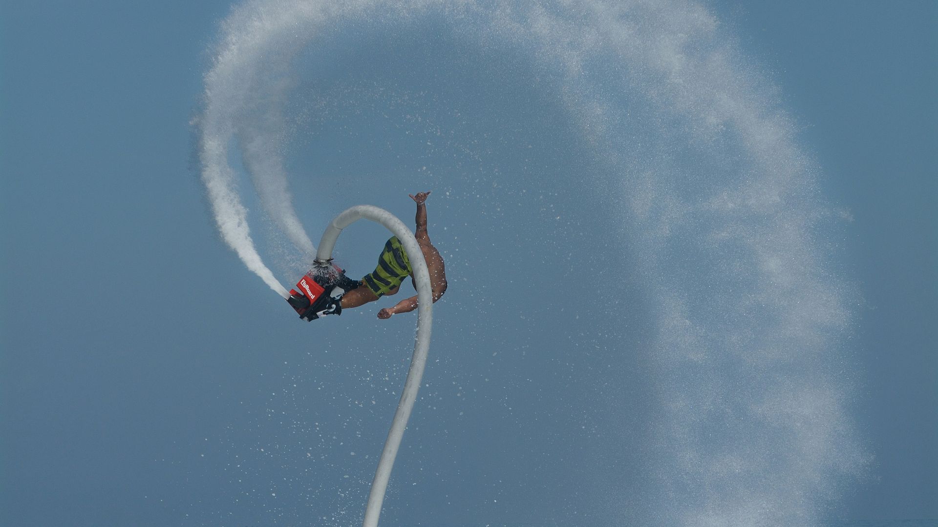 A man riding a jet ski while being pulled by a boat