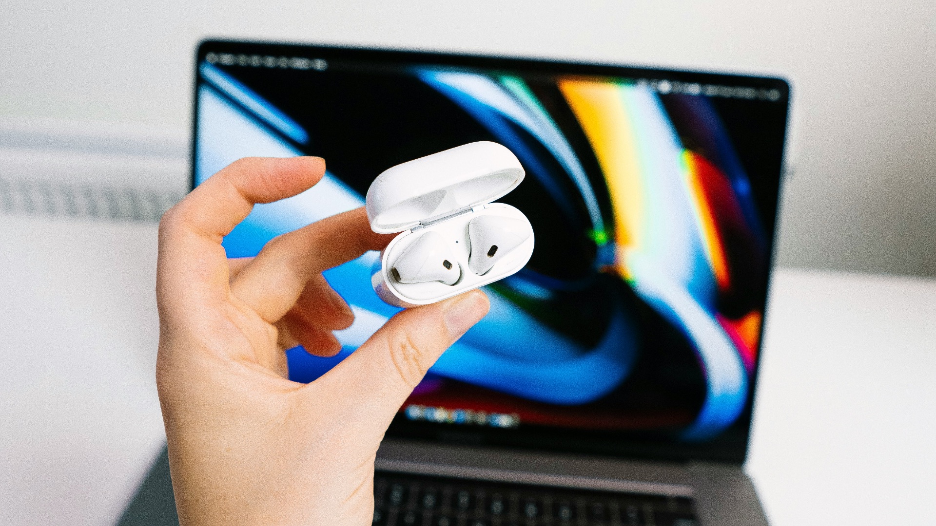 person holding iphone with white and blue iphone case