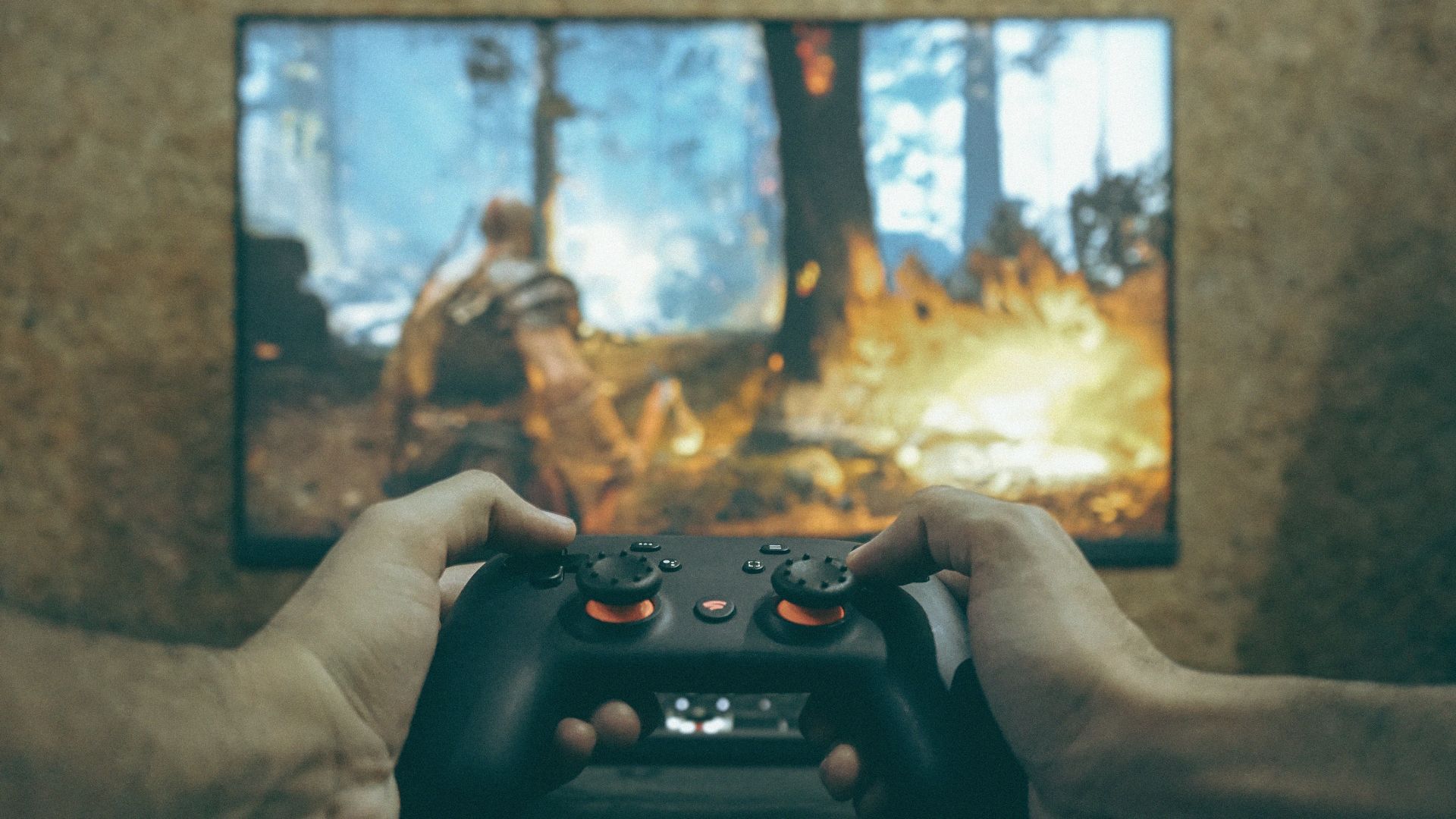 Hands holding a game controller playing a video game.