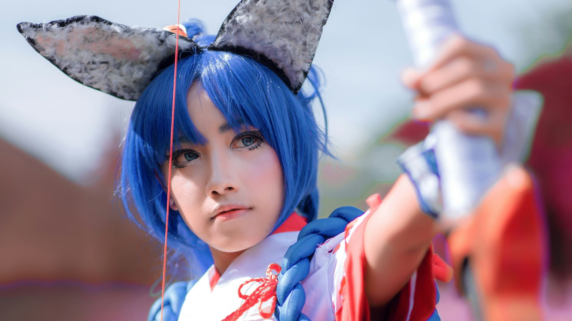 girl in blue and red long sleeve shirt holding a umbrella