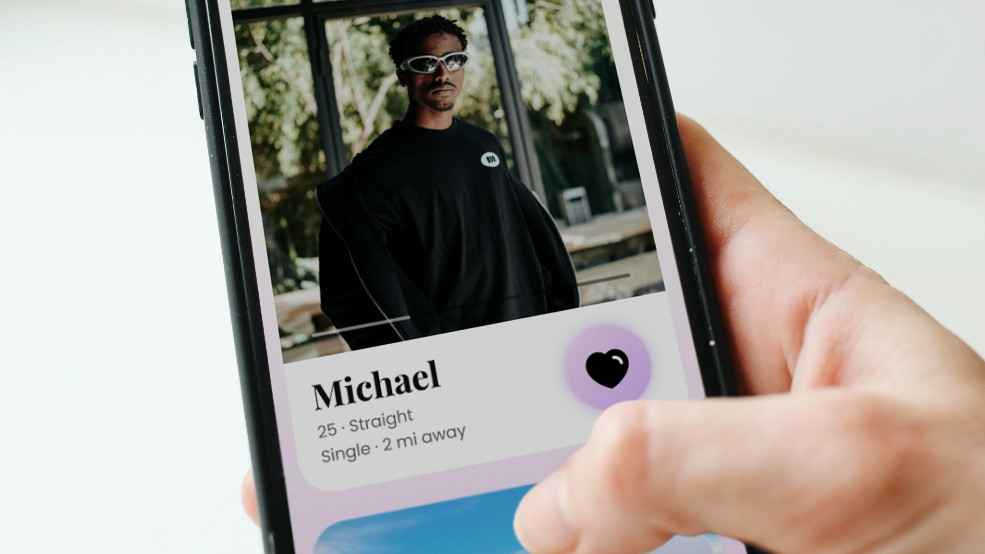 a person holding a cell phone with a picture of a man on it