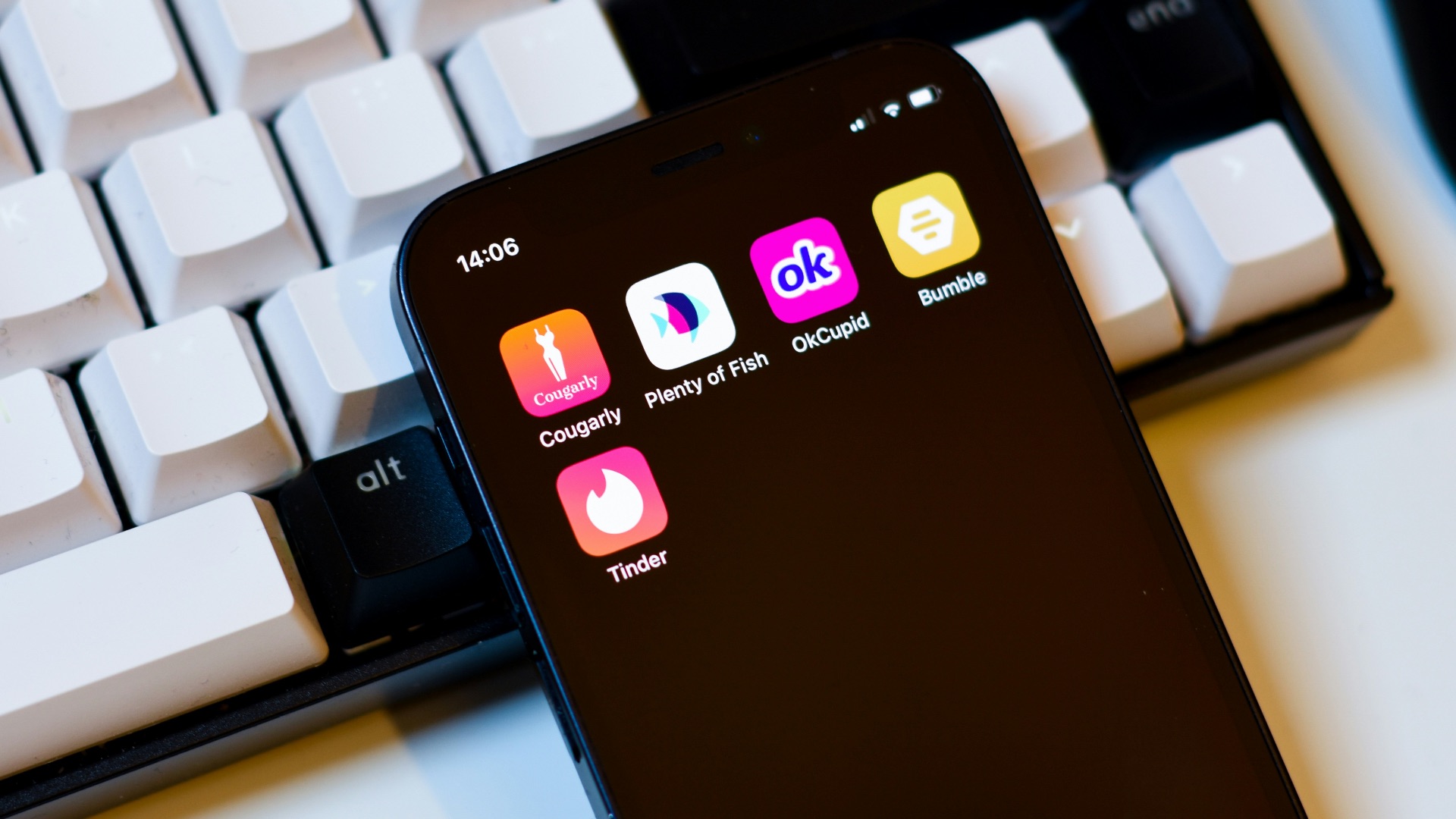 a cell phone sitting next to a keyboard