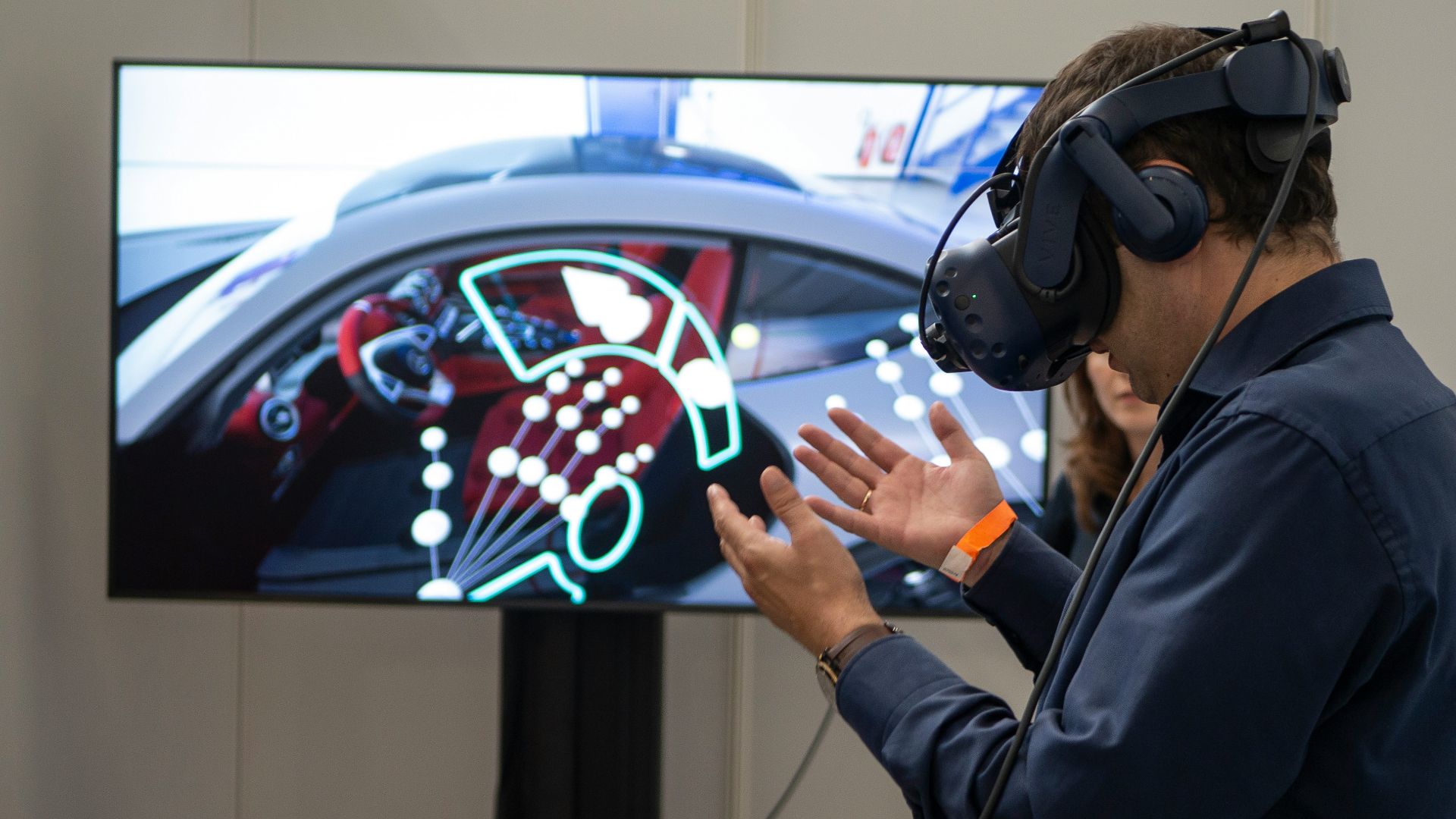 man in black jacket holding blue and white plastic cup